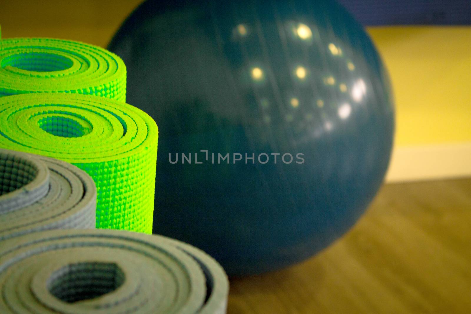 Yoga mat on wooden floor to perform meditation exercises