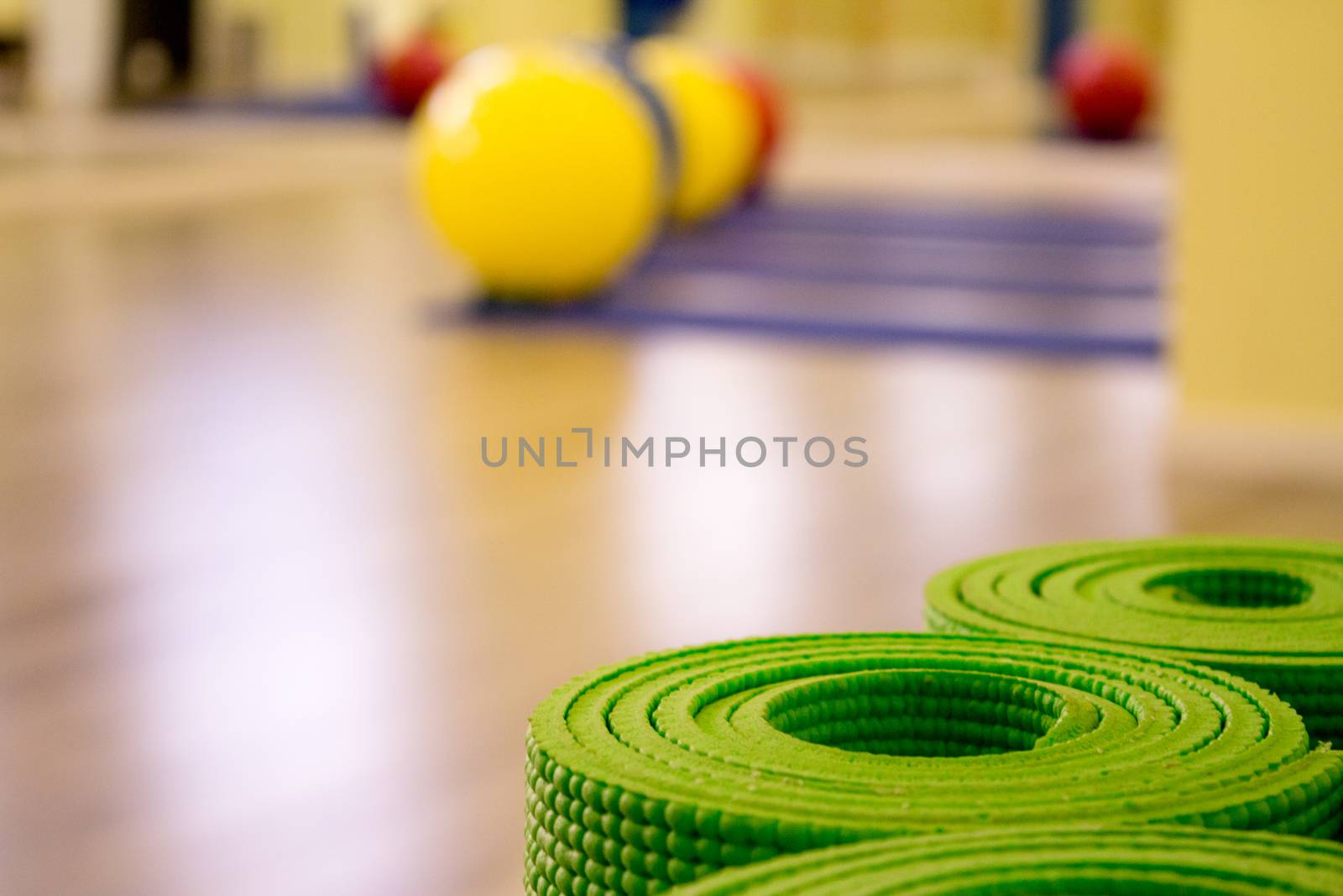 Yoga mat on wooden floor to perform meditation exercises