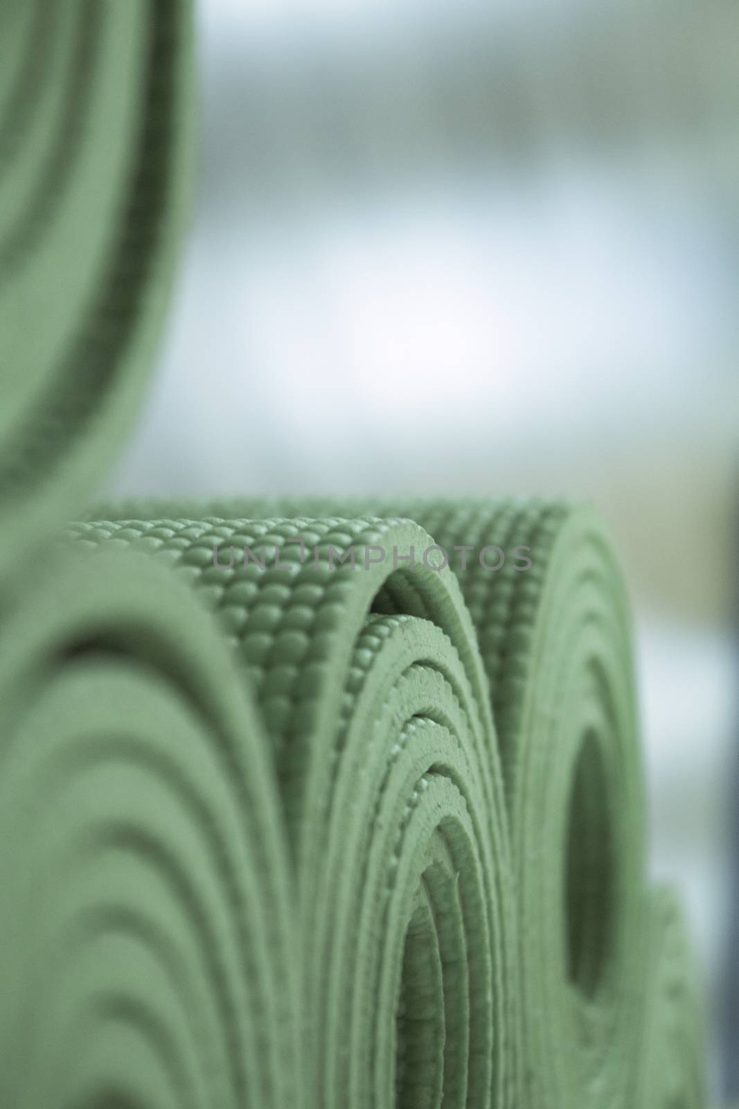 Yoga mat on wooden floor to perform meditation exercises