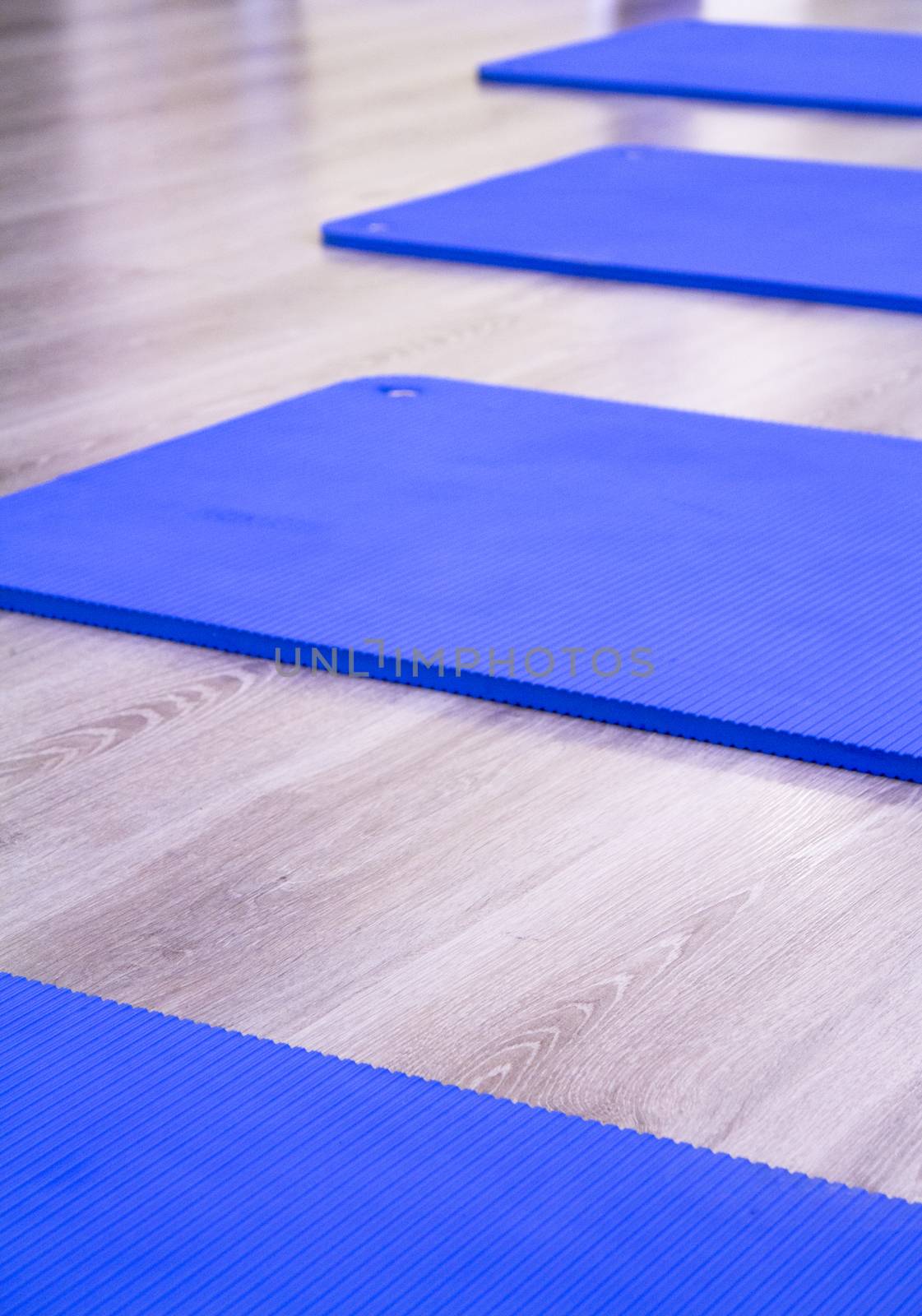 Yoga mat on wooden floor to perform meditation exercises