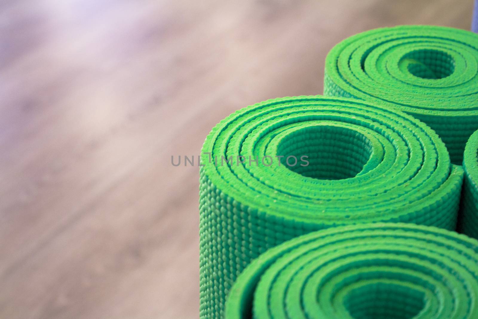 Yoga mat on wooden floor to perform meditation exercises
