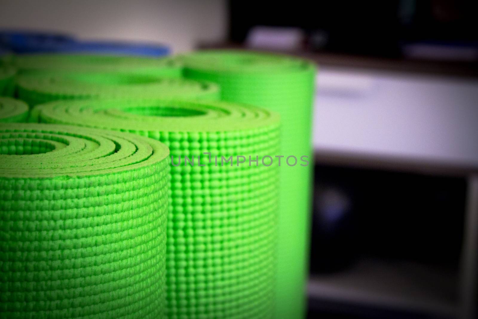 Yoga mat on wooden floor to perform meditation exercises