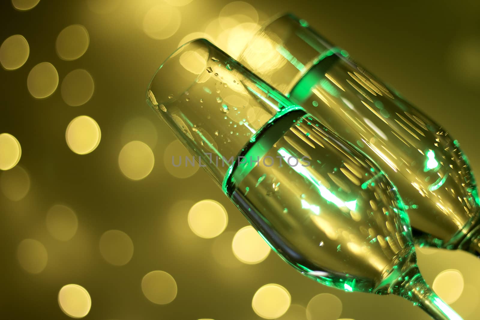 Champagne pouring in glass with festive background