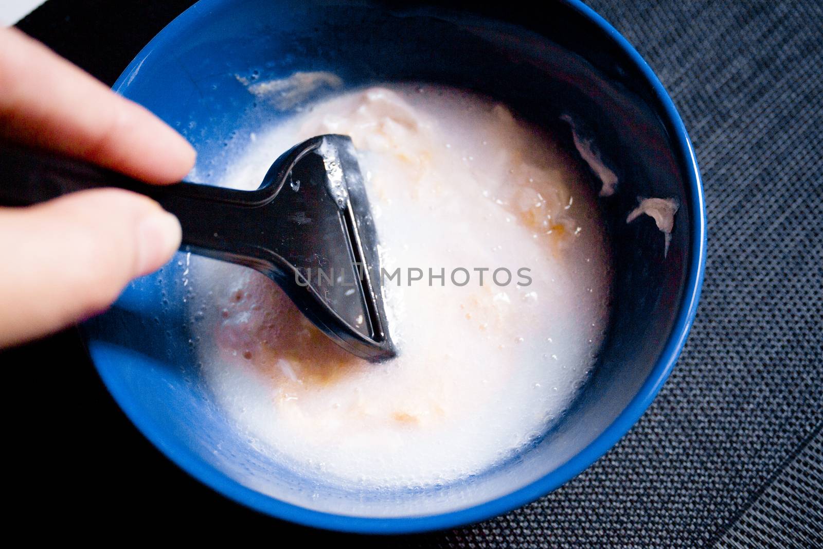 Woman removing hair dye mixture