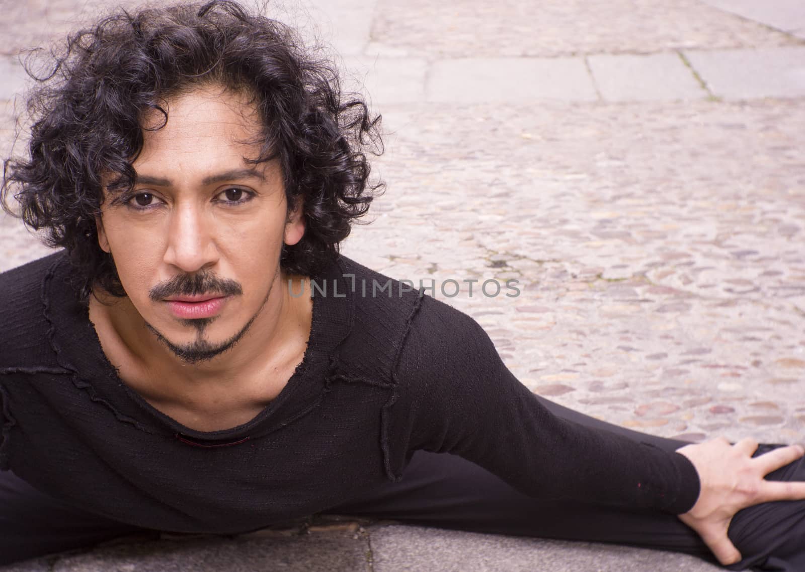Portrait of latin man with beard and black curly hair