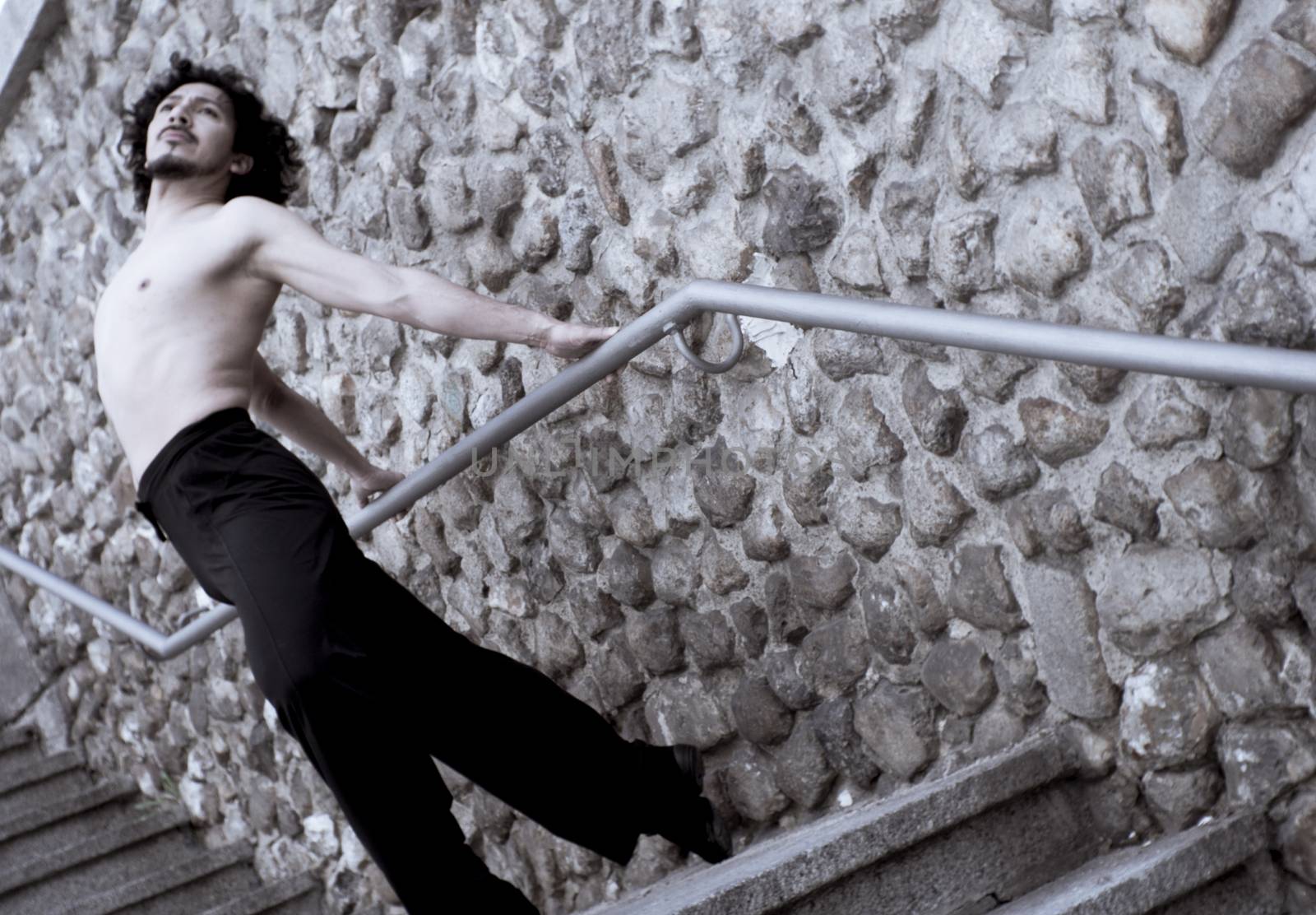 Male dancer doing a classic ballet pirouette. Urban background