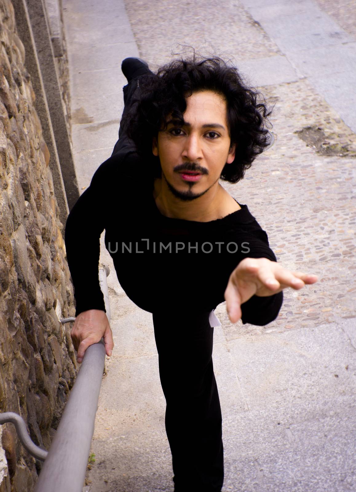 Male dancer doing a classic ballet pirouette. Urban background
