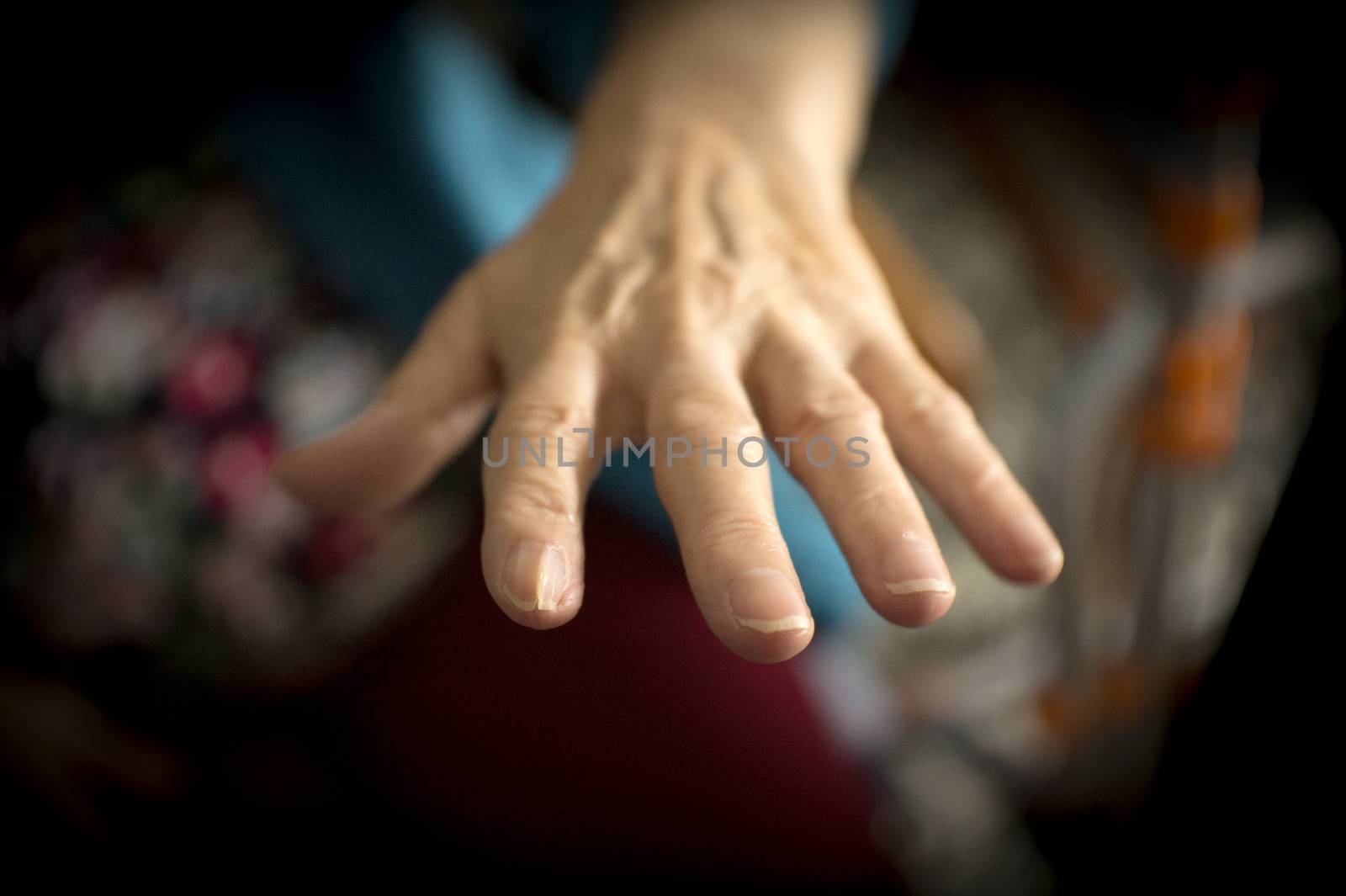 Hands of elderly woman with alzheimer doing massage