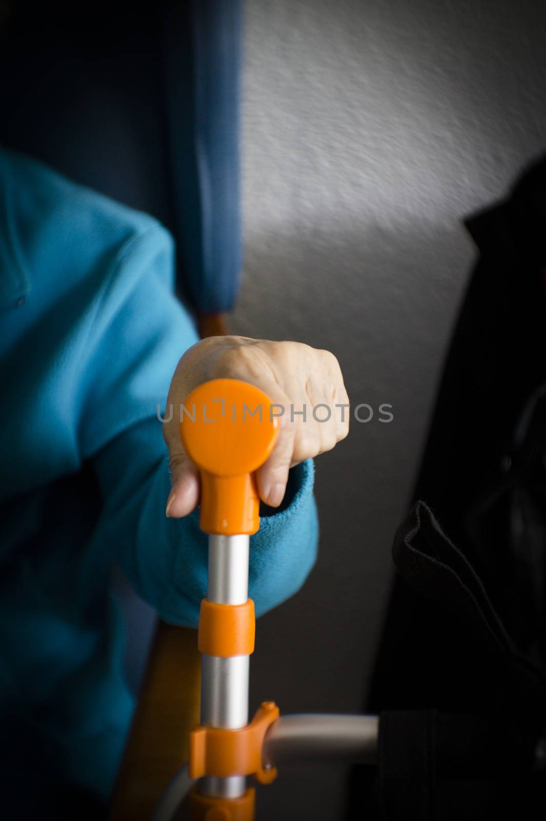 Elderly womans hand resting on her walker