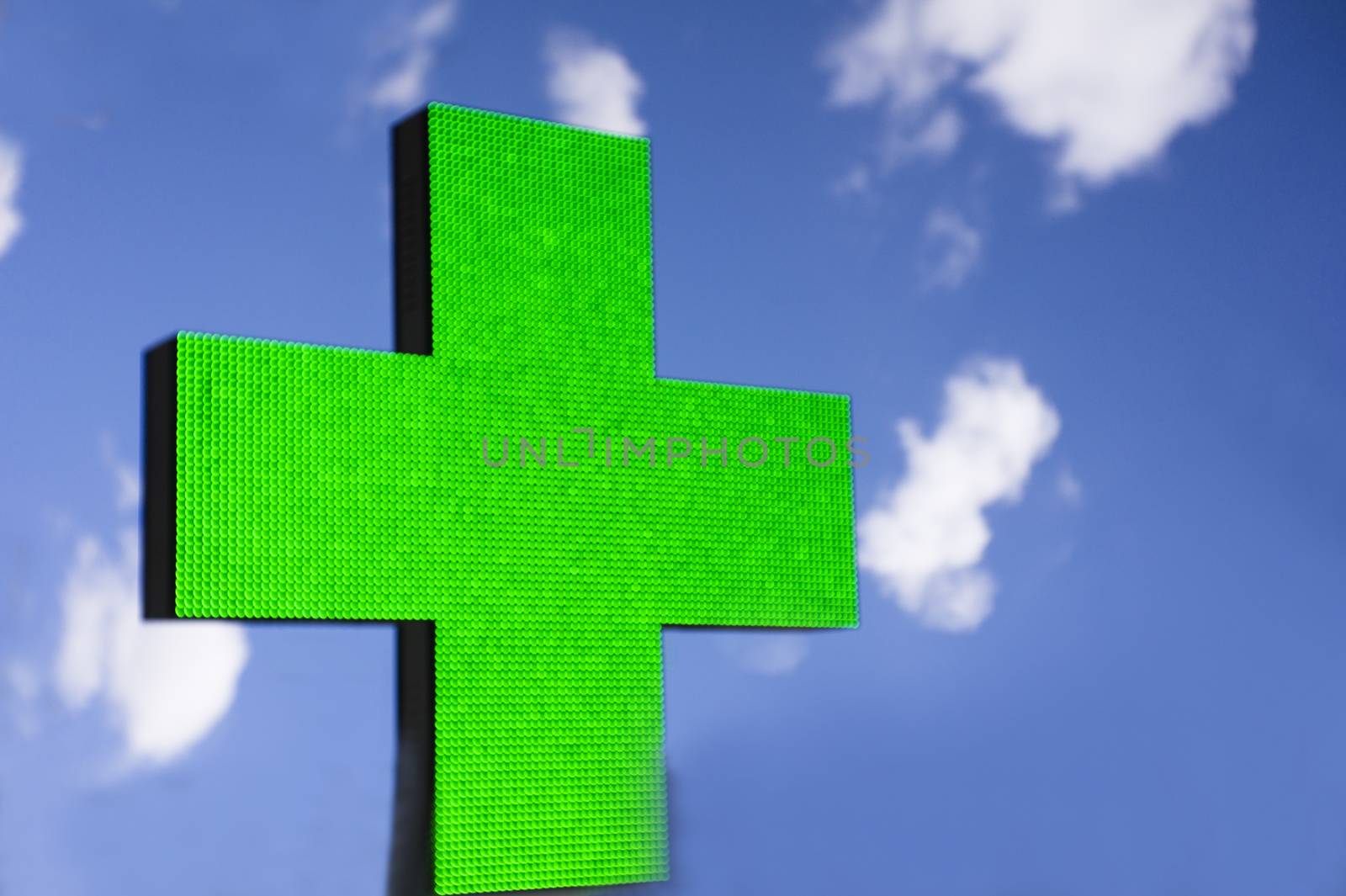 Sign in the shape of a cross indicating the existence of a pharmacy
