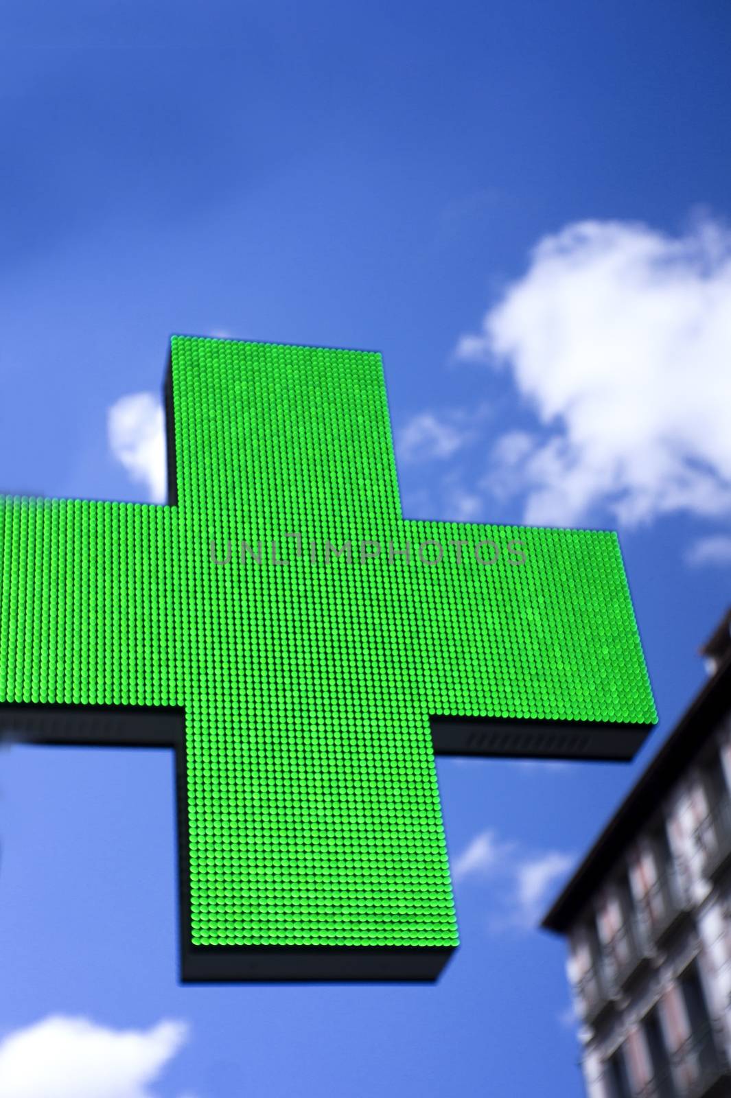 Sign in the shape of a cross indicating the existence of a pharmacy