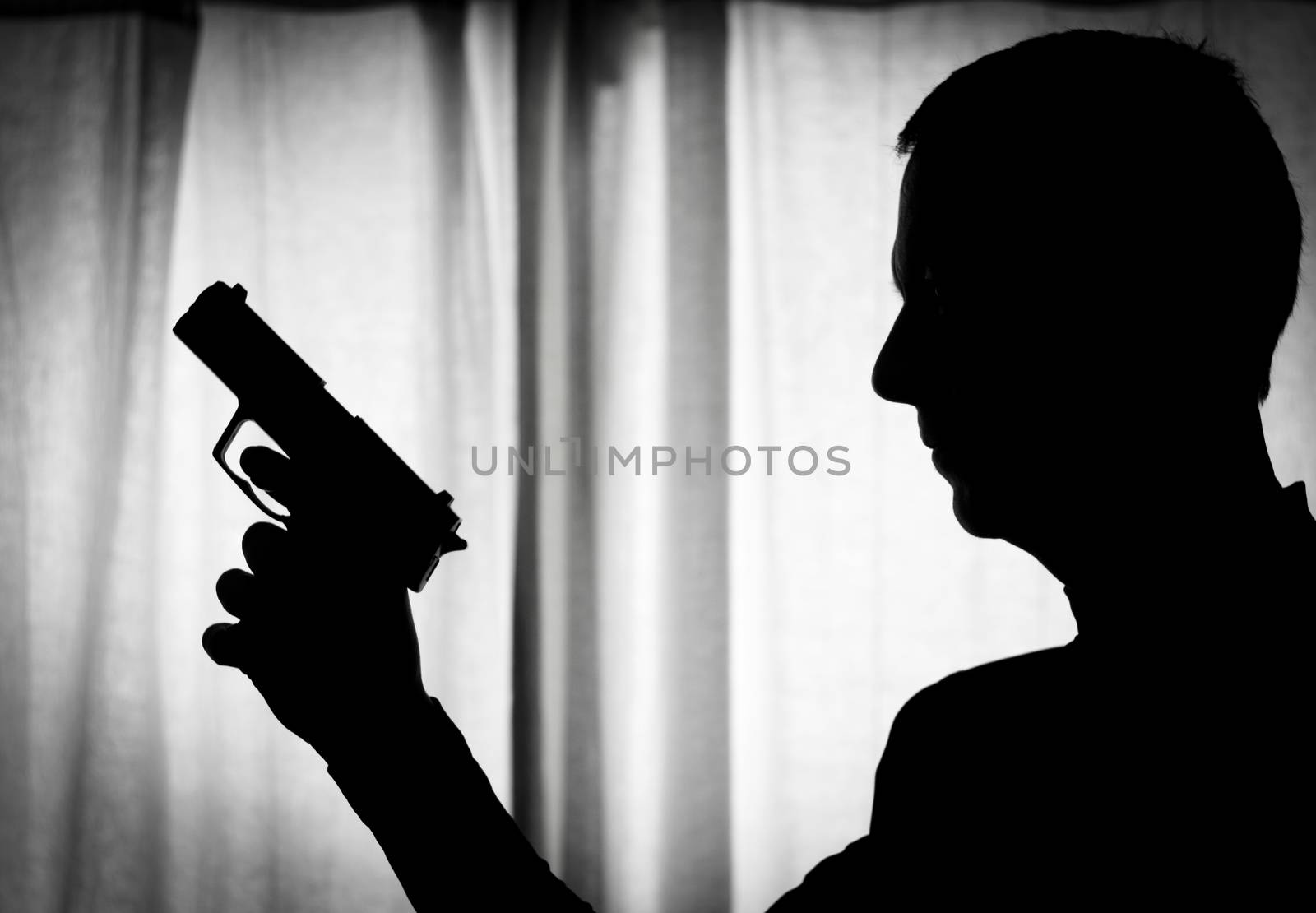 Man in a position of alert with a gun in his hand