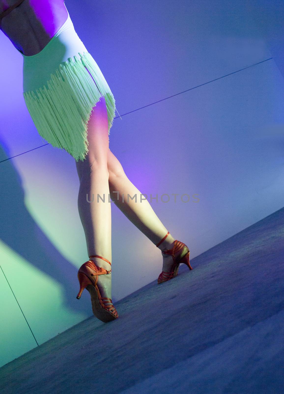 Woman with green dress dancing latin dance 