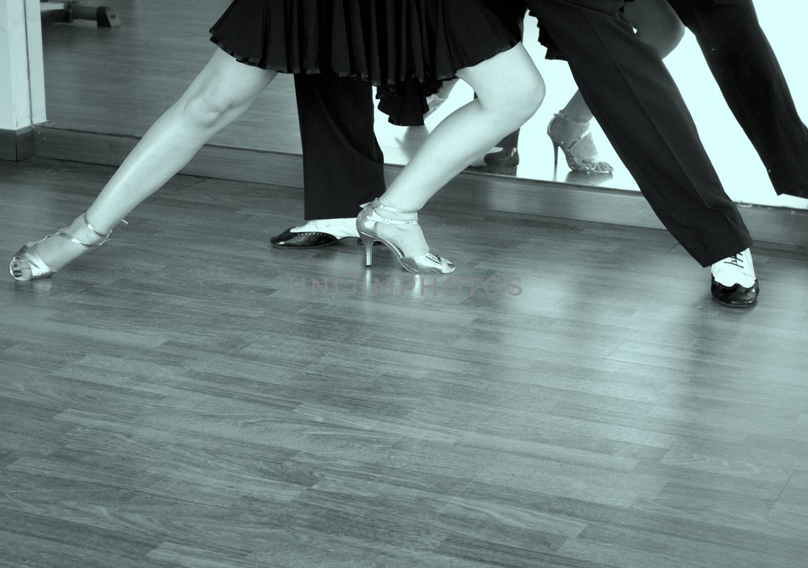 Couple of dancers dancing lindy hop in bright gold and black and white shoes
