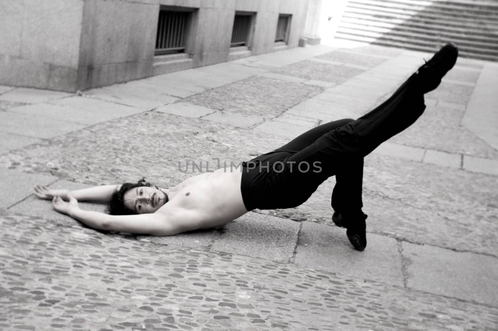 Male dancer in ballet pose. Street background