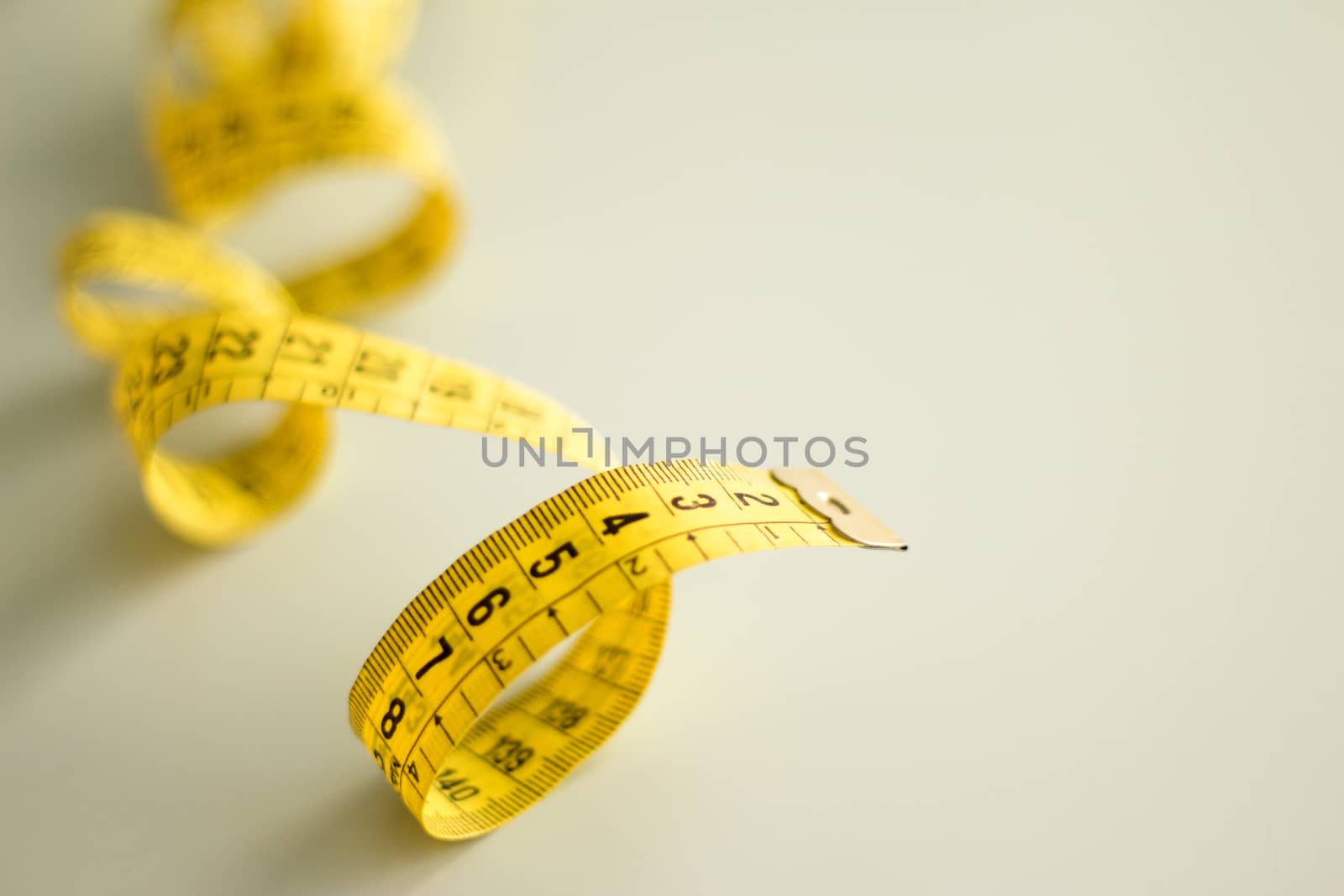 Yellow tape measure rolled. No people