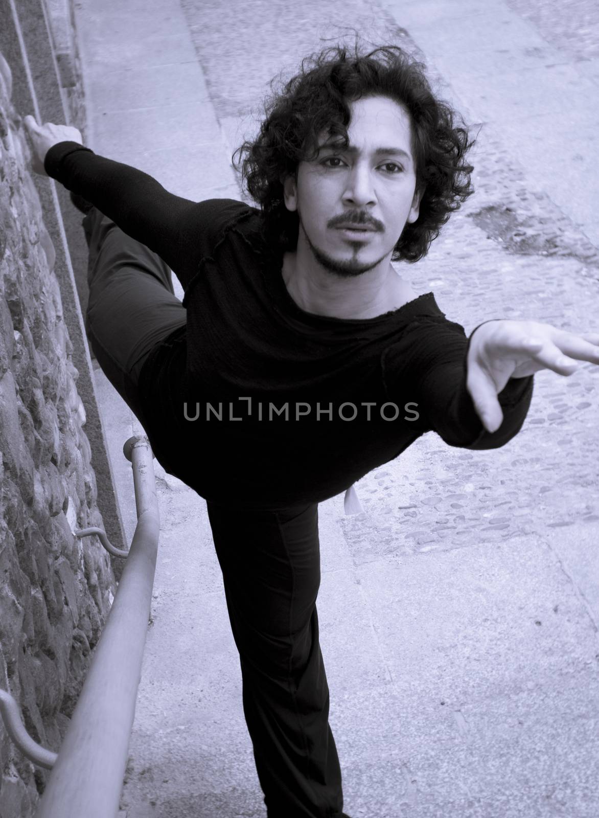 Male dancer doing a classic ballet pirouette. Urban background