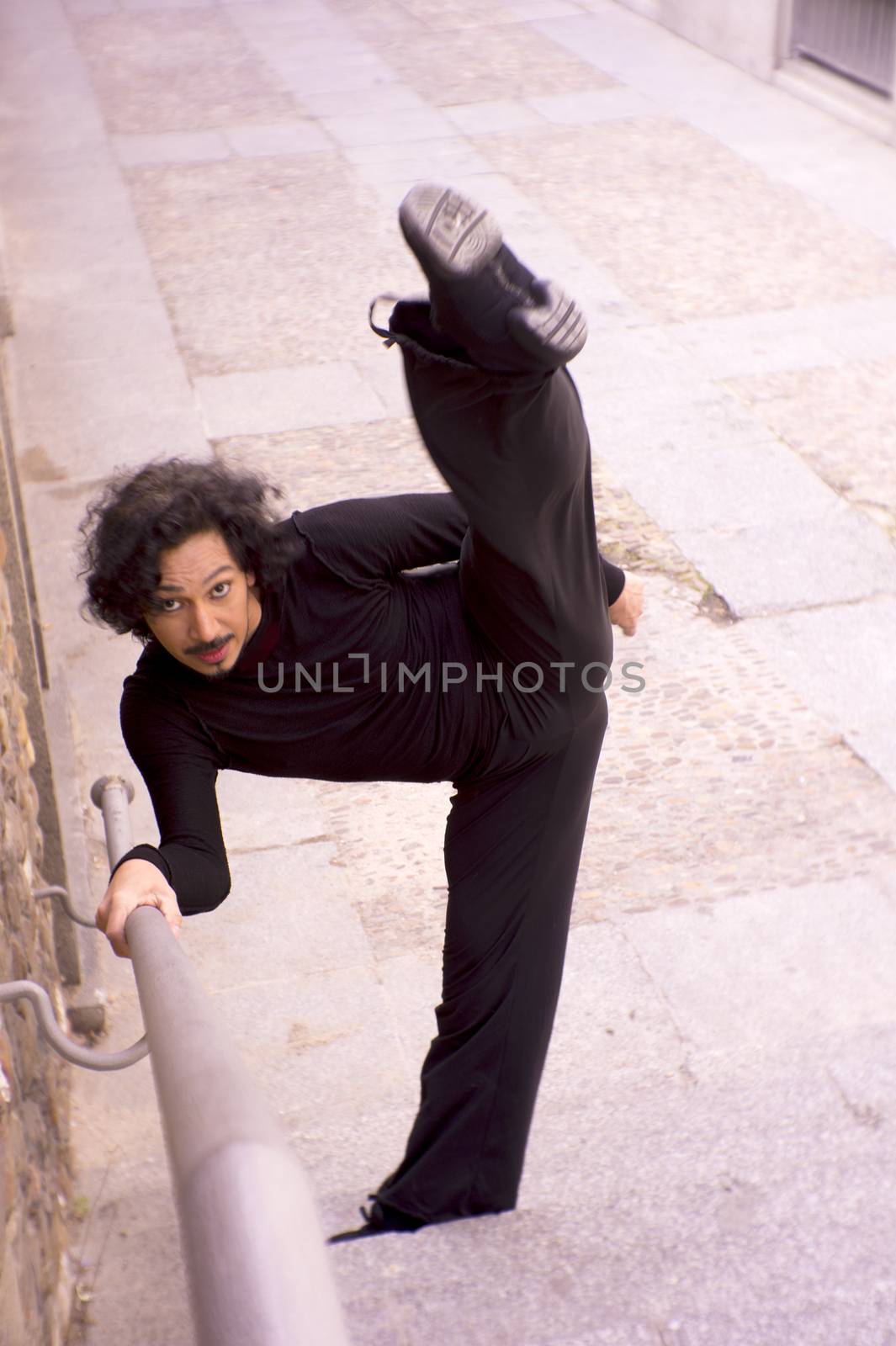 Male dancer doing a classic ballet pirouette. Urban background