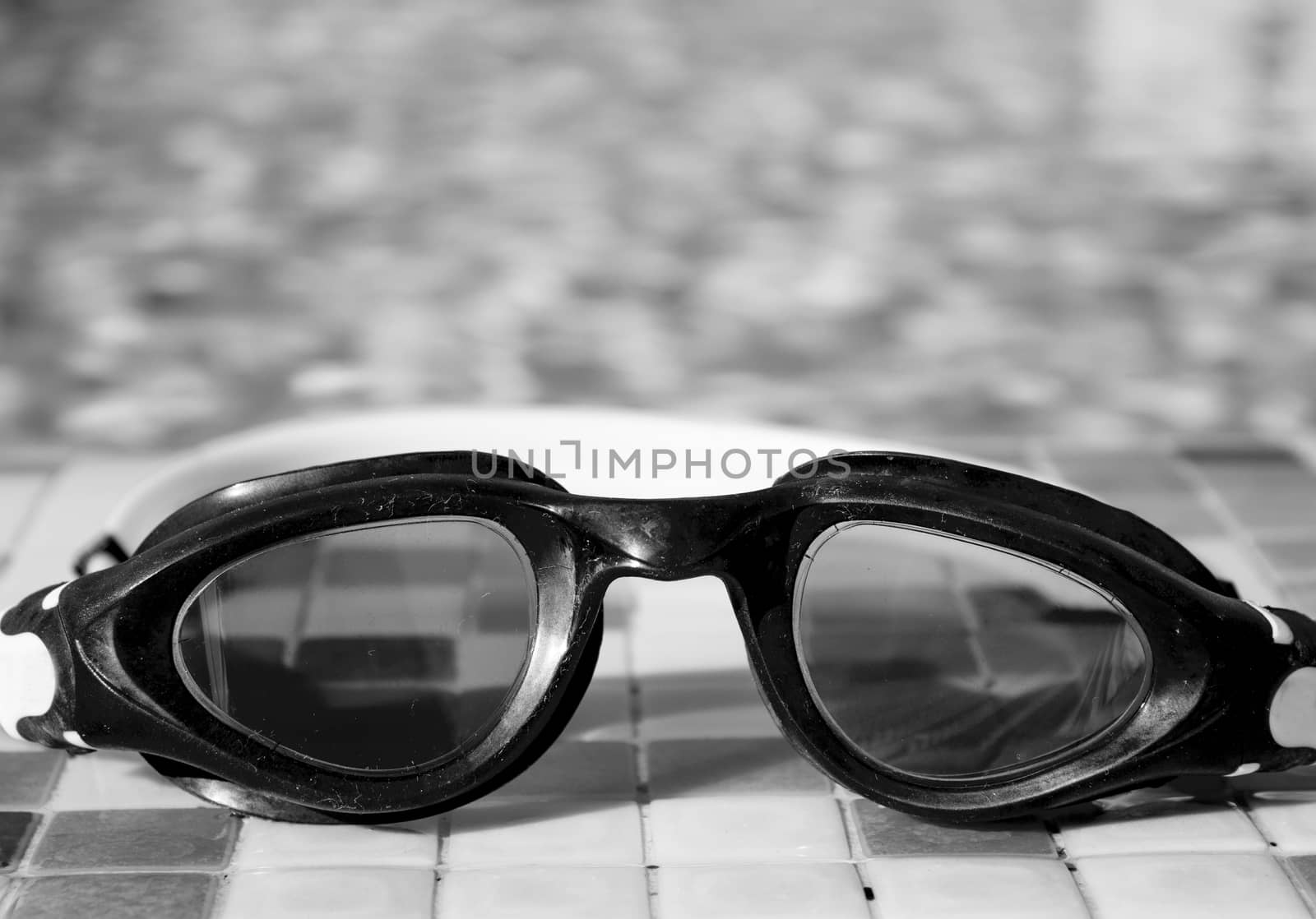 Glasses for diving on the edge of a summer pool. No people