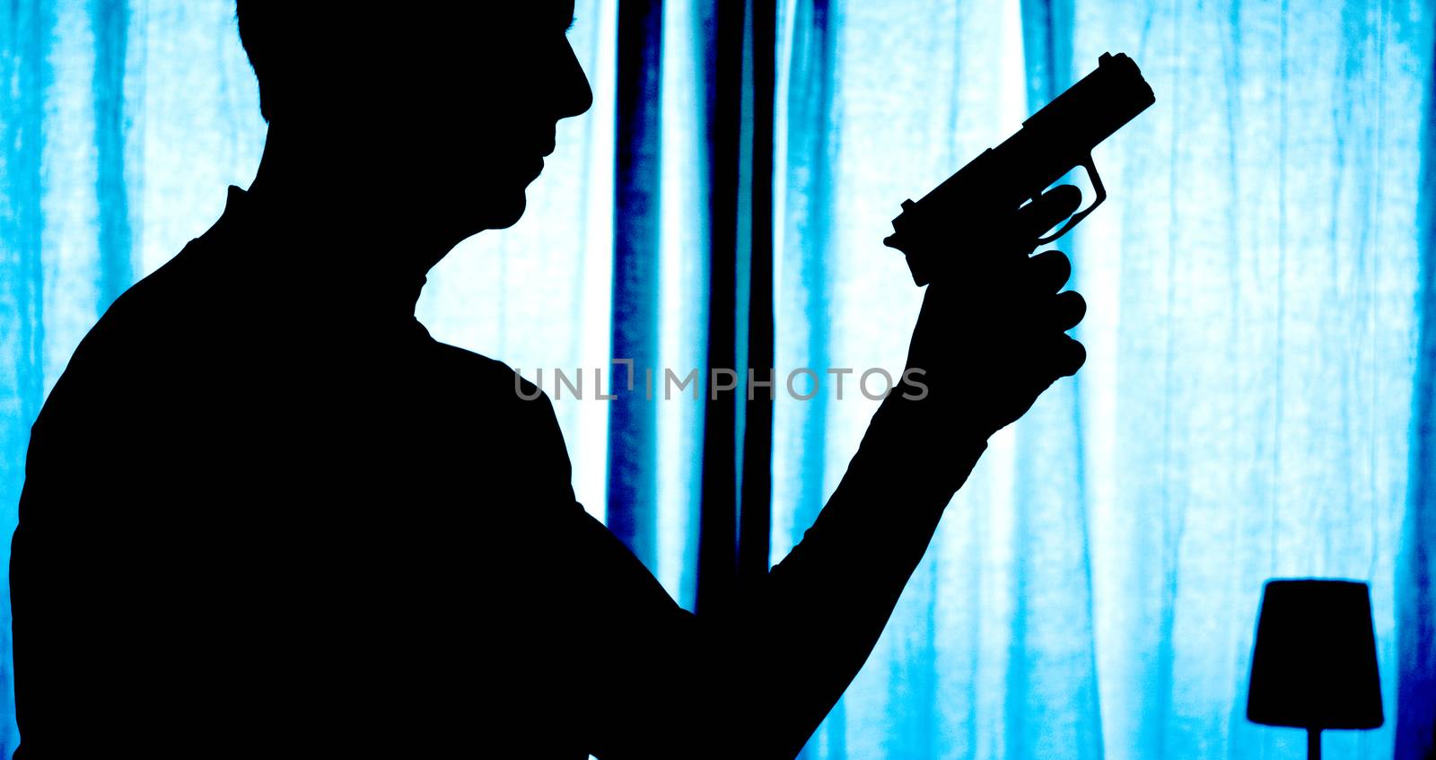 Man in a position of alert with a gun in his hand
