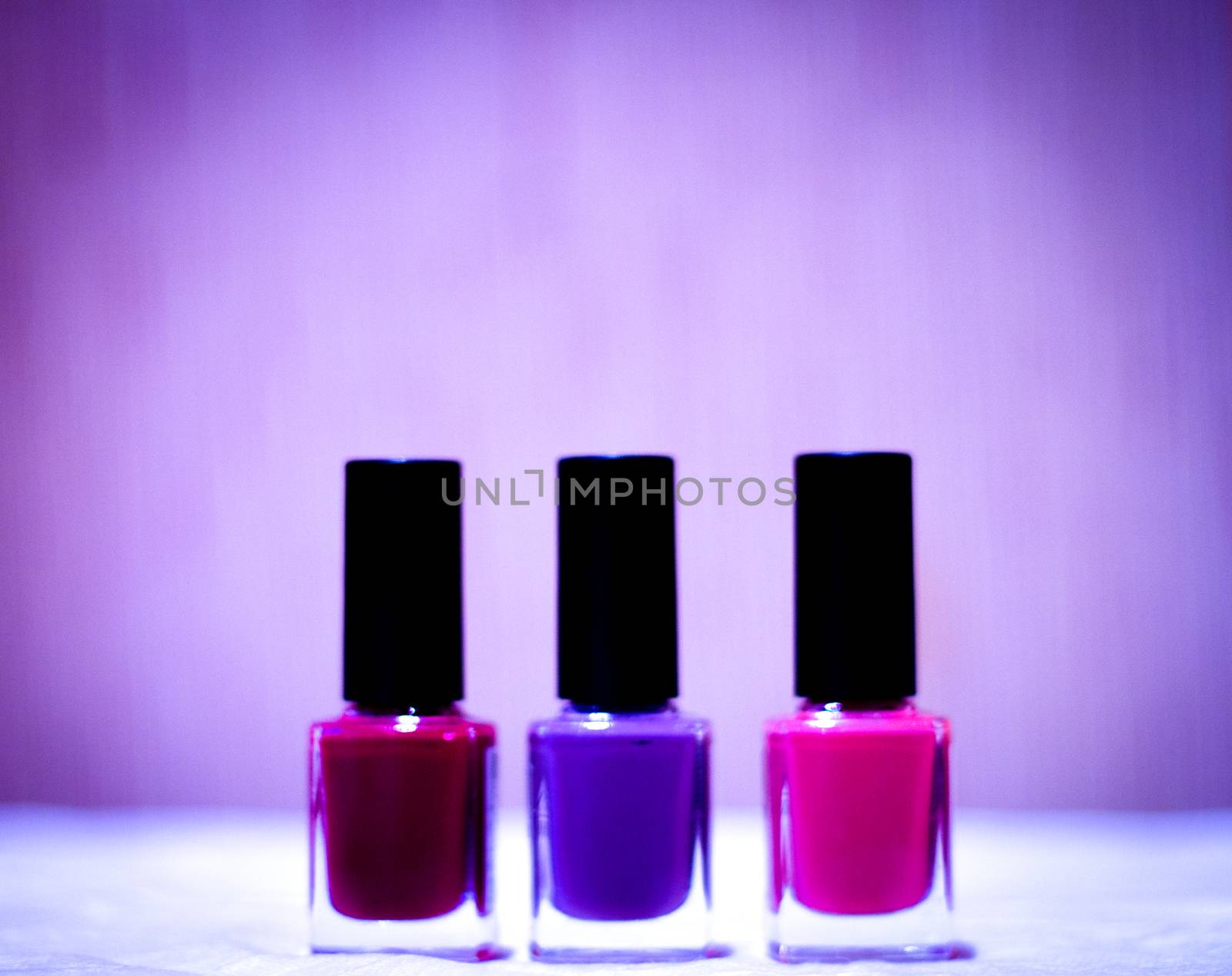 Nail polishes with strong colors. No people. Copy space