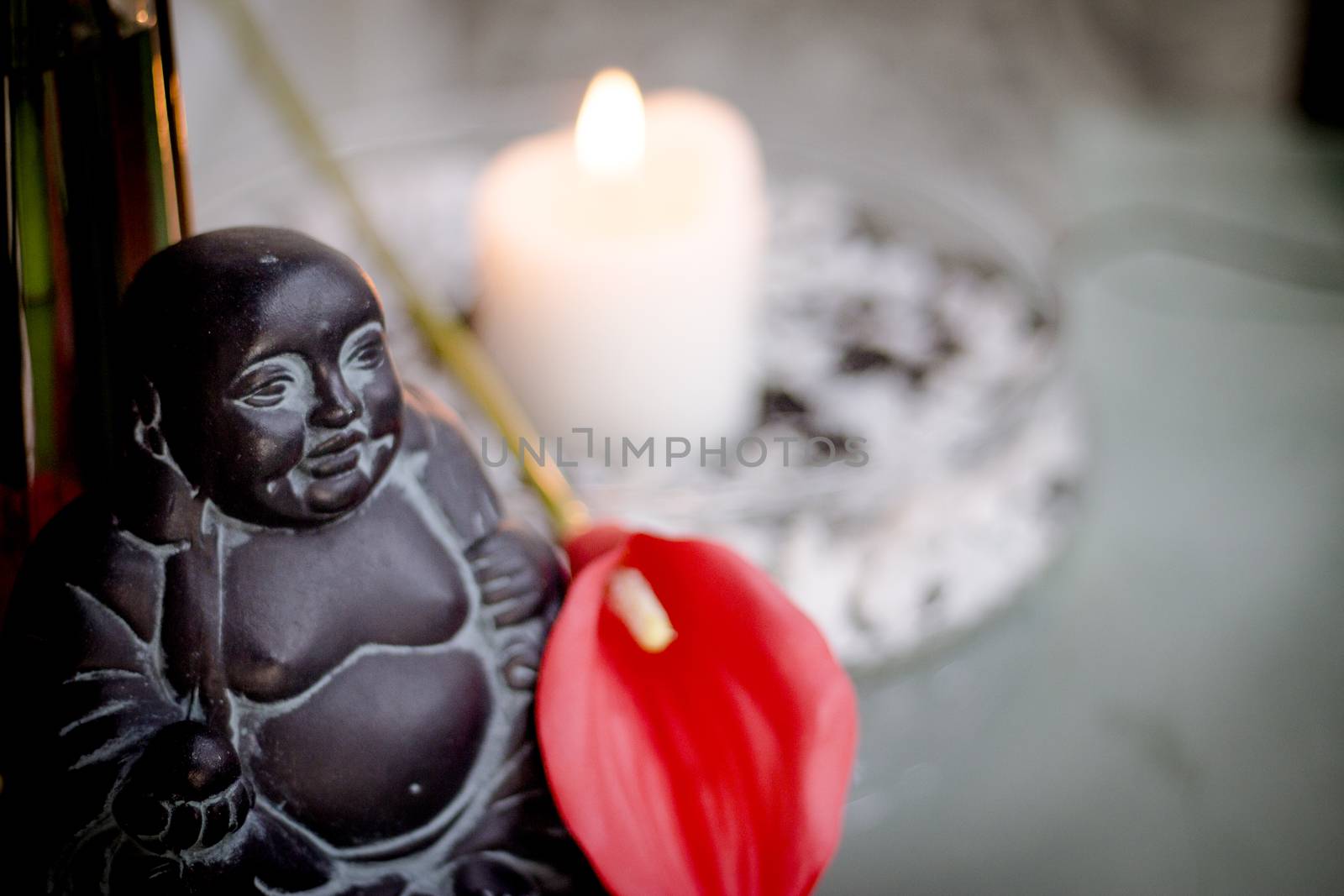 Generic buddha decoration with candle and flower. Relax scene
