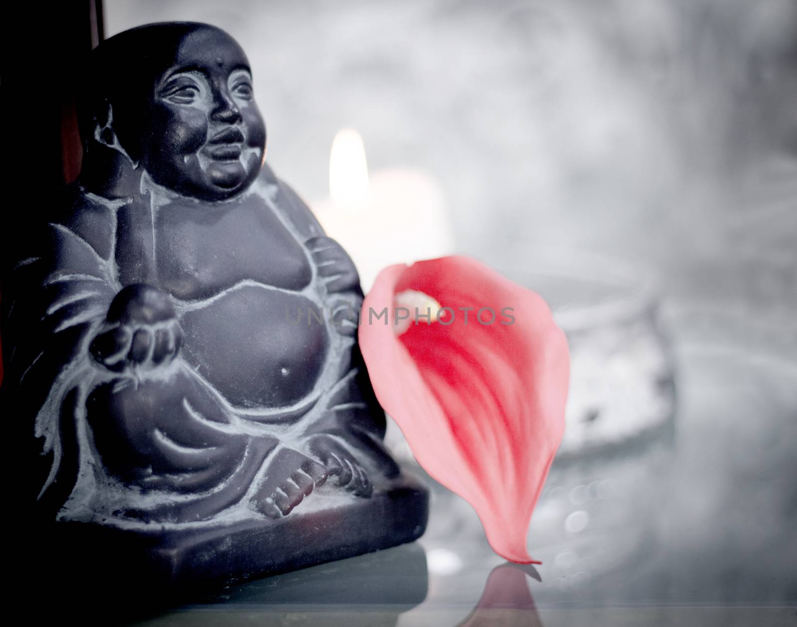 Generic buddha decoration with candle and flower. Relax scene