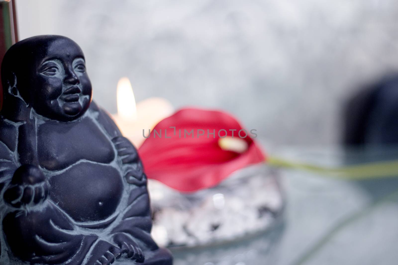 Generic buddha decoration with candle and flower. Relax scene