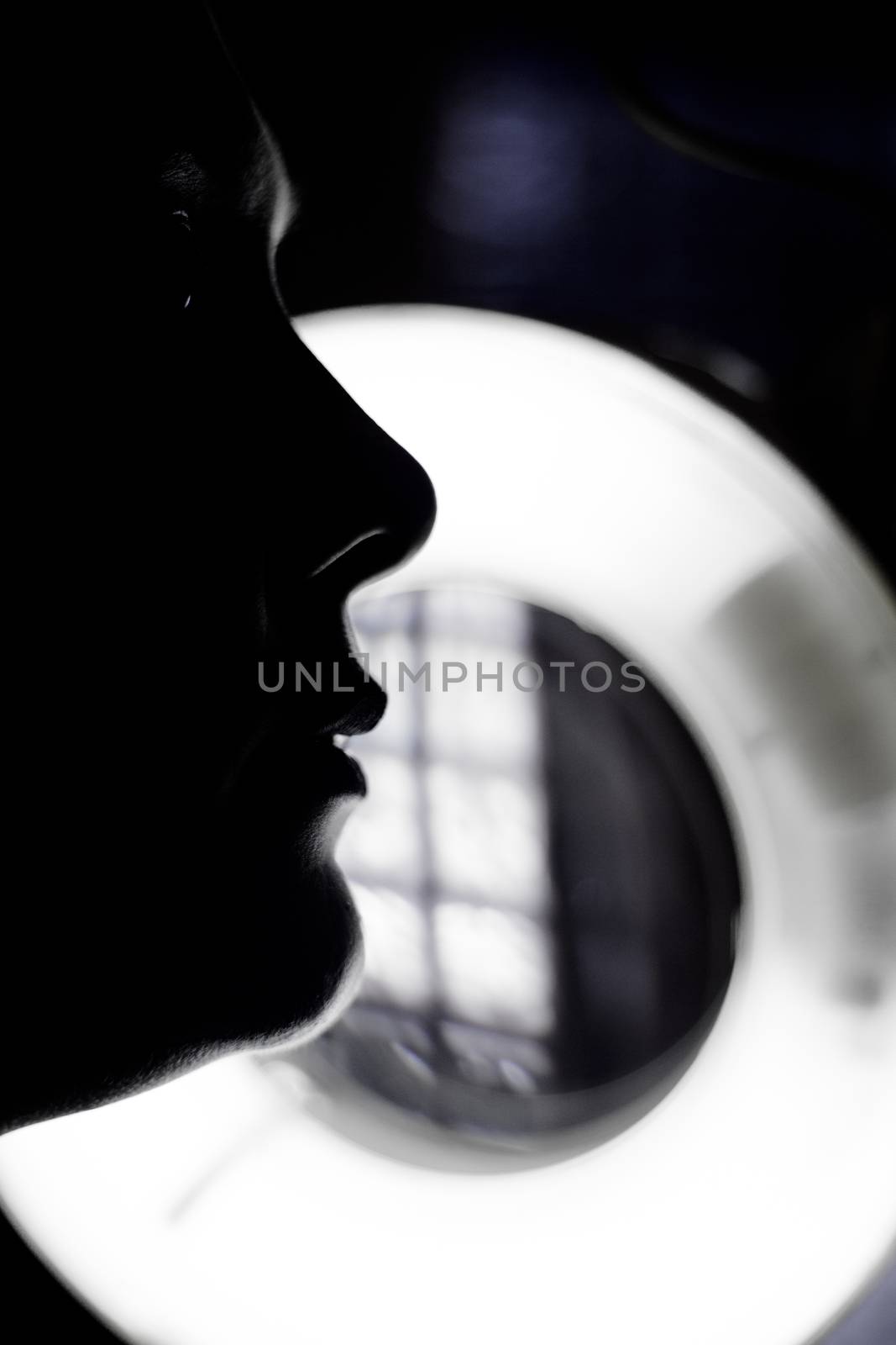 Silhouette of woman portrait making up over unfocused background