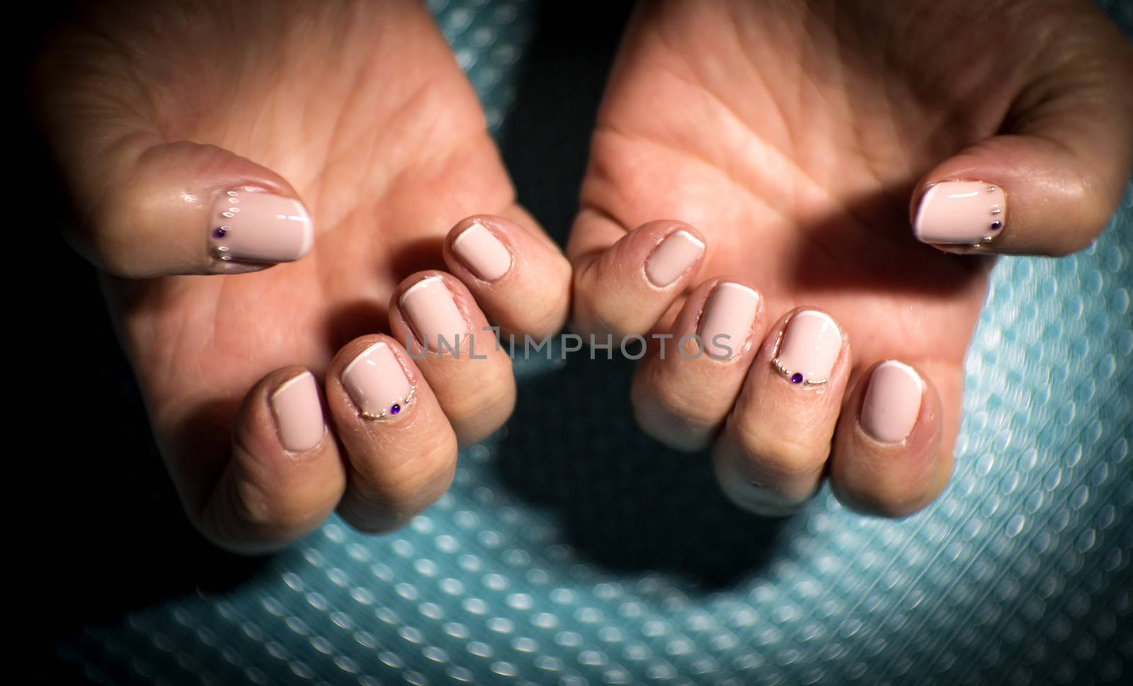 Womans hands showing semi-permanent beige manicure