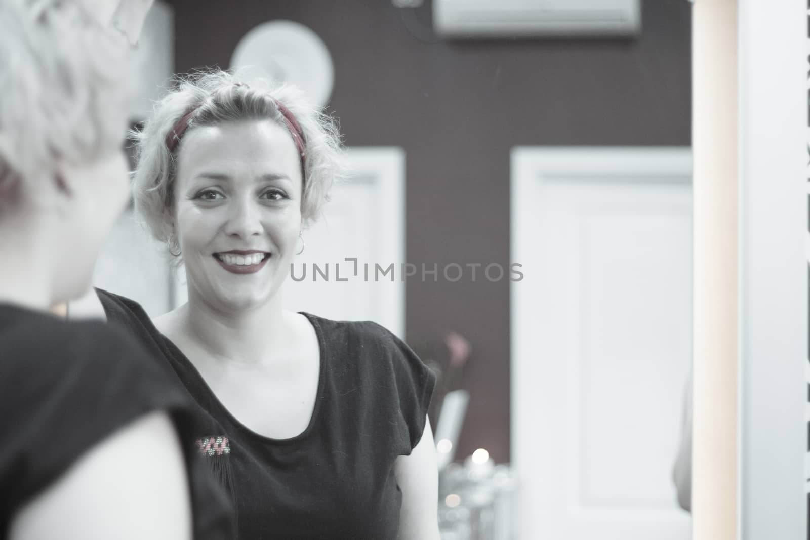 Portrait of blonde woman with short hair and pinup style. Relaxed expression