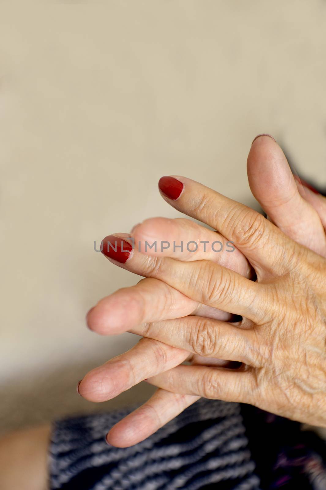 Hands of old woman and elderly caregiver