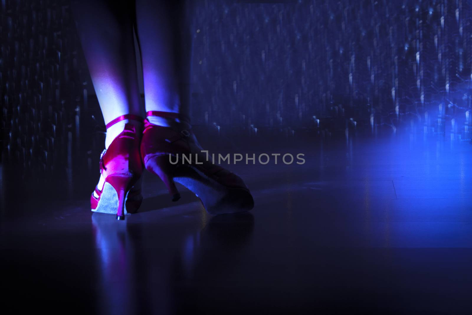 Woman with red dancing sandals in disco