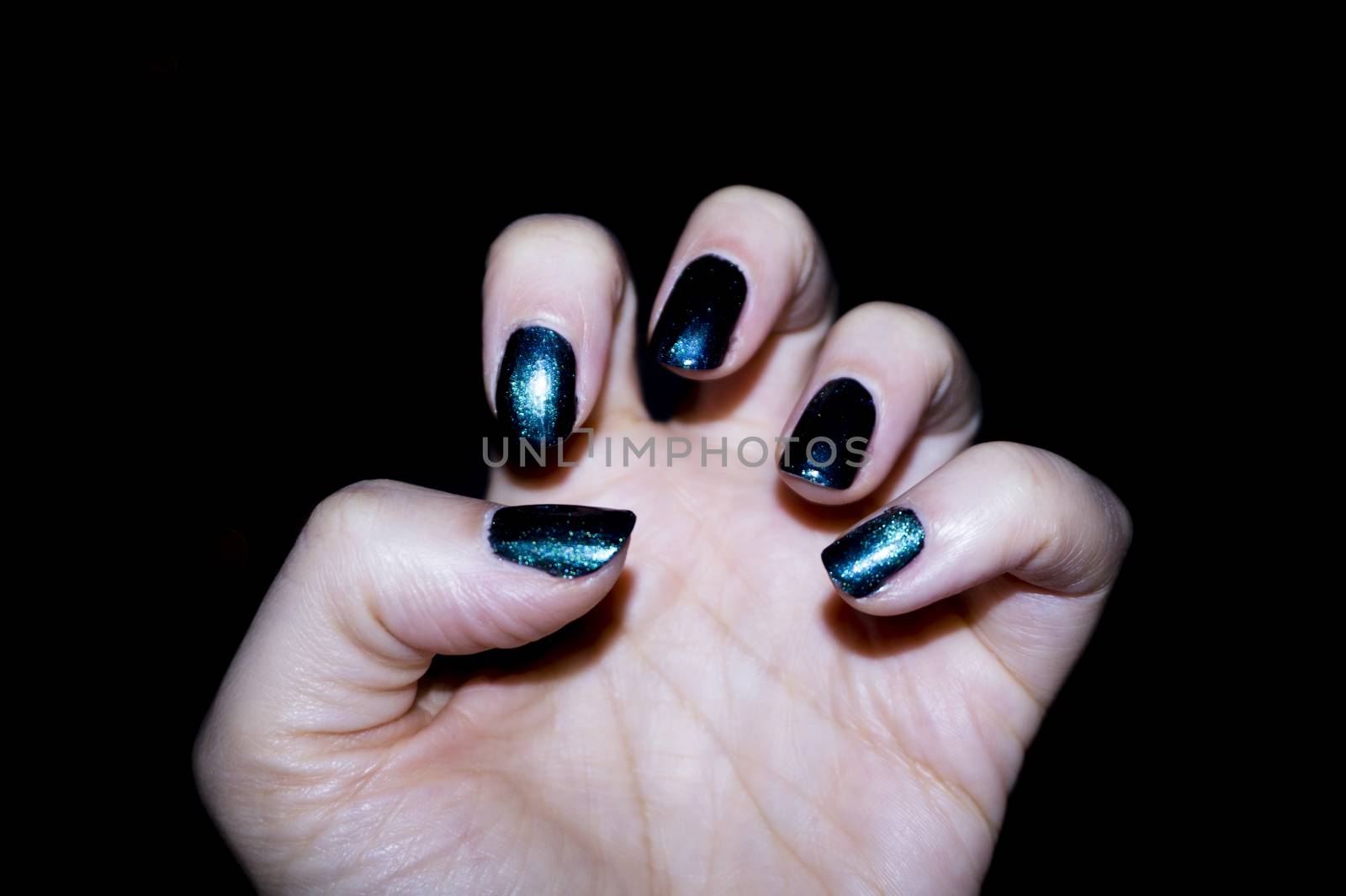 Woman hand manicure green colour