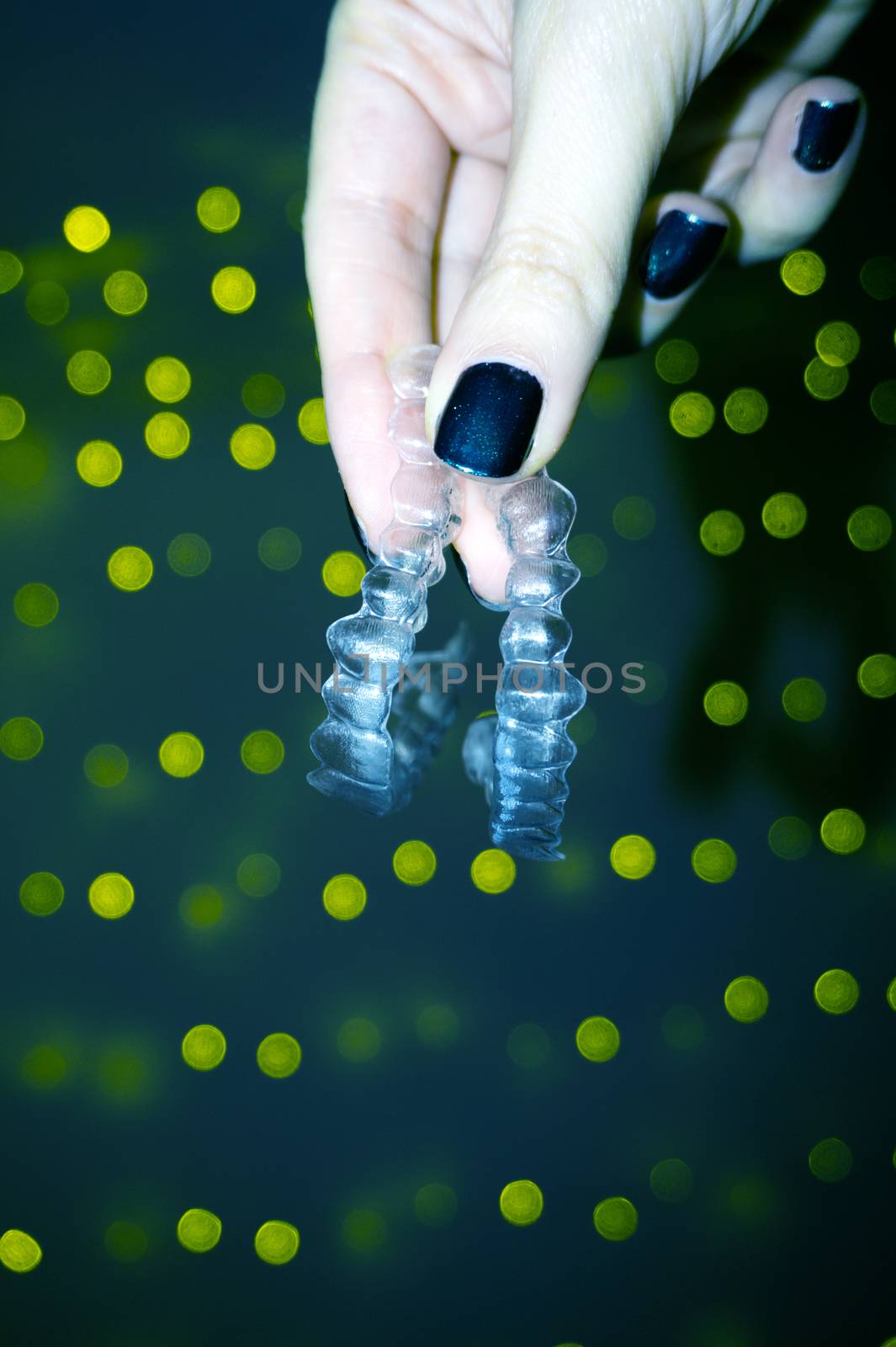 Woman hand holding denture alignment retainer