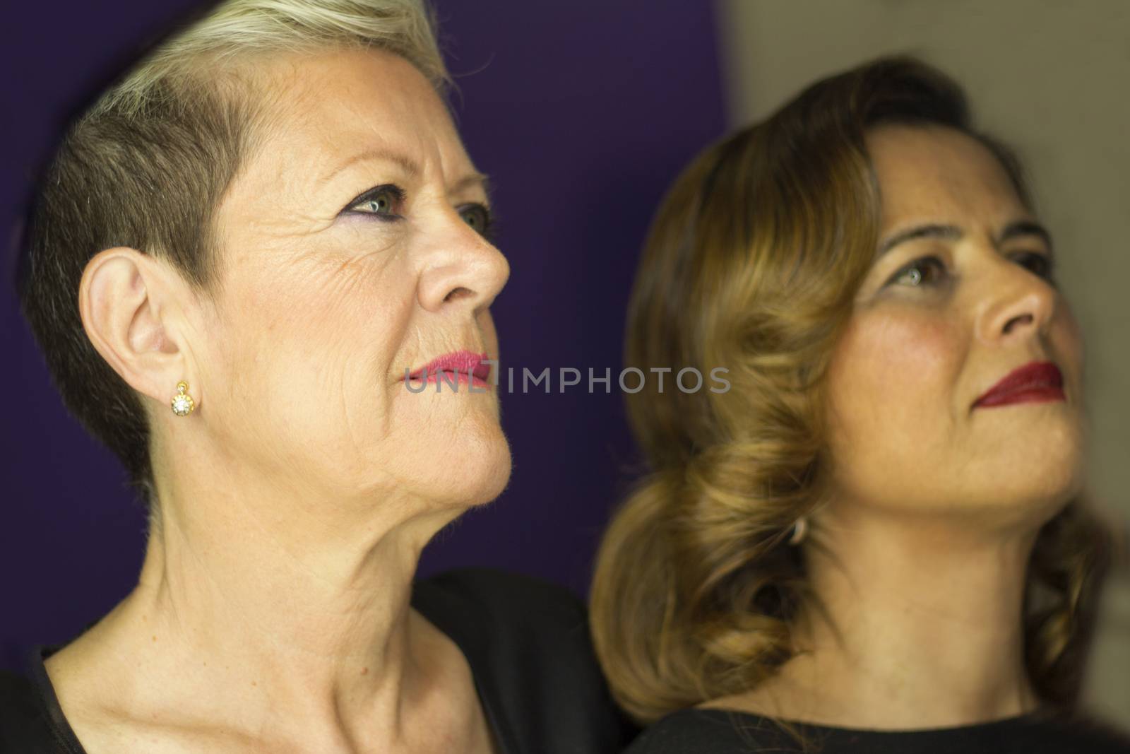 Woman with platinum blonde short hair and woman with wavy brown long hair