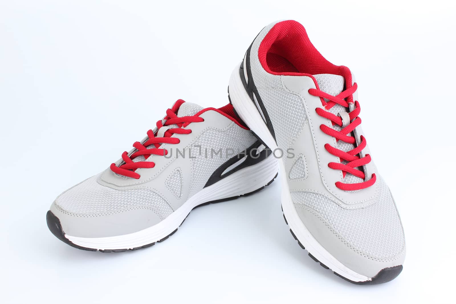 Gray sneakers with red laces on a white background by Mizkit