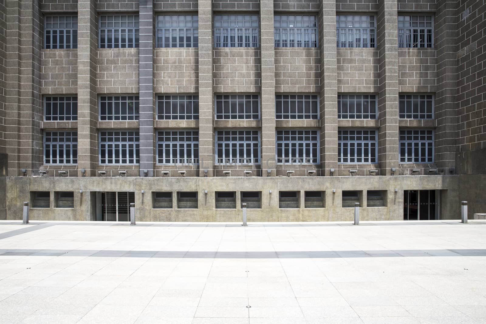 Empty pavement front view of office entrance facade of old style business center