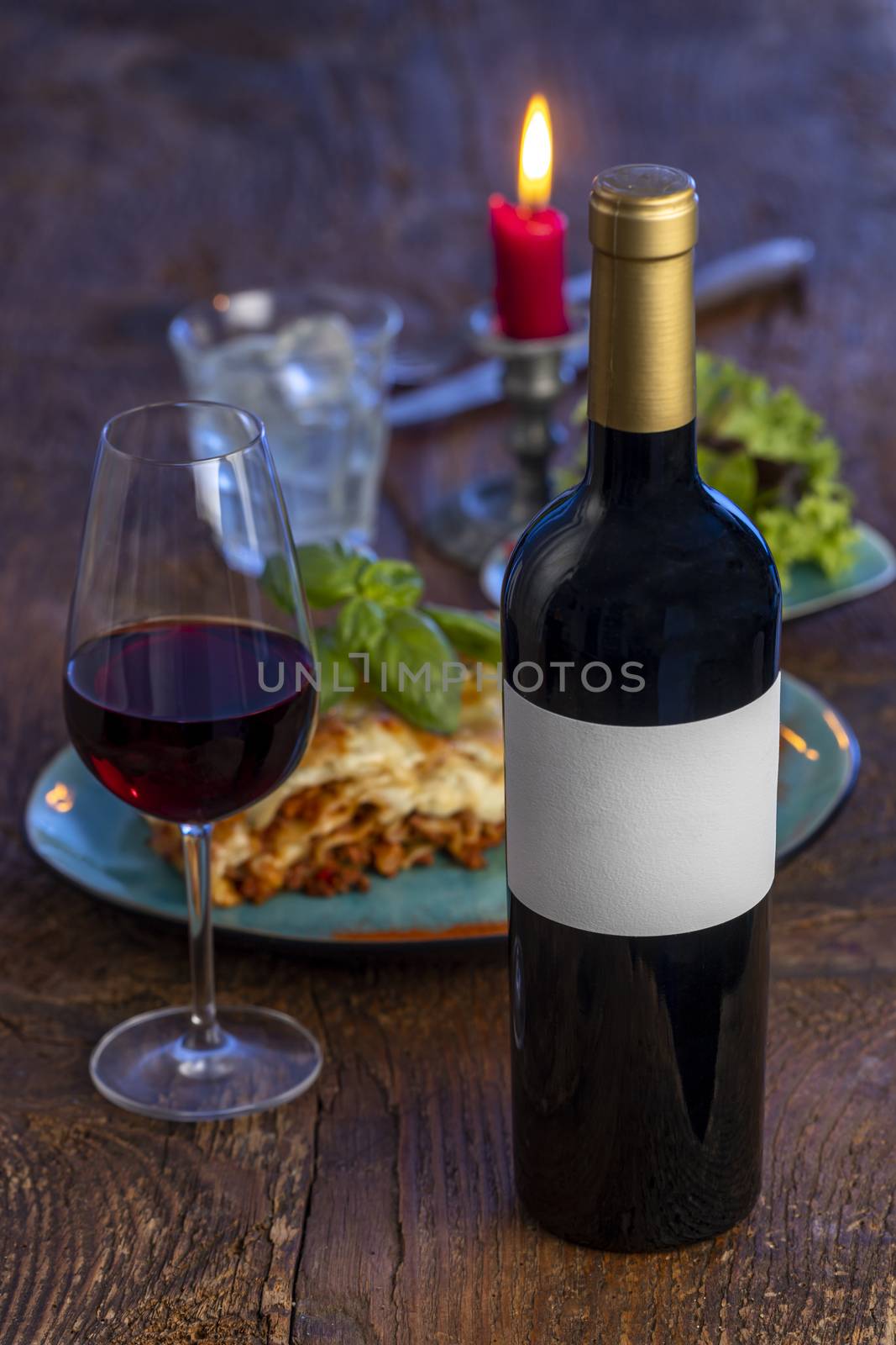 red wine and lasagna on wood