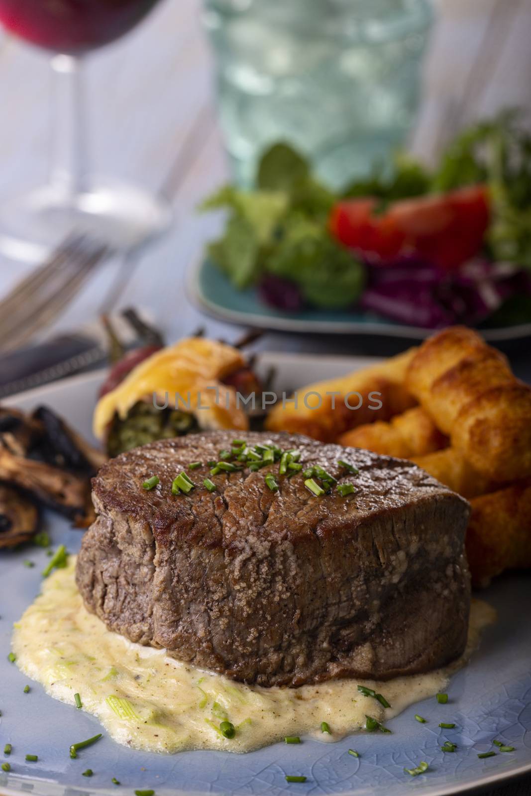 closeup of a steak on a plate by bernjuer