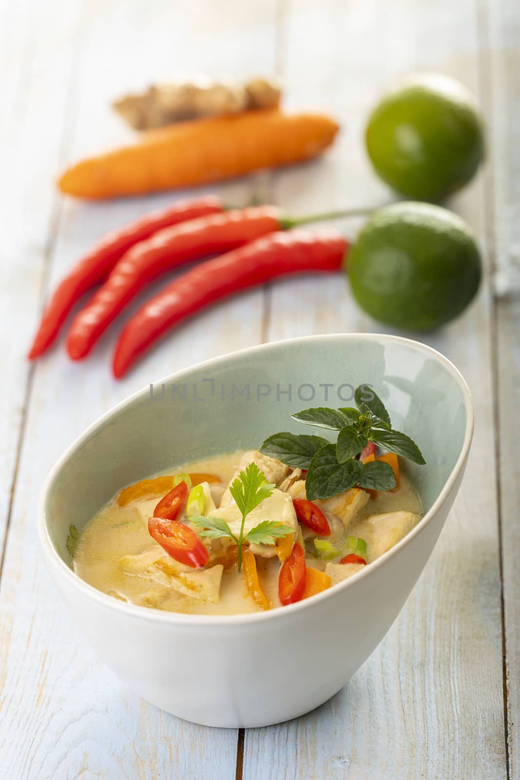 thai tom kha gai soup on wood by bernjuer