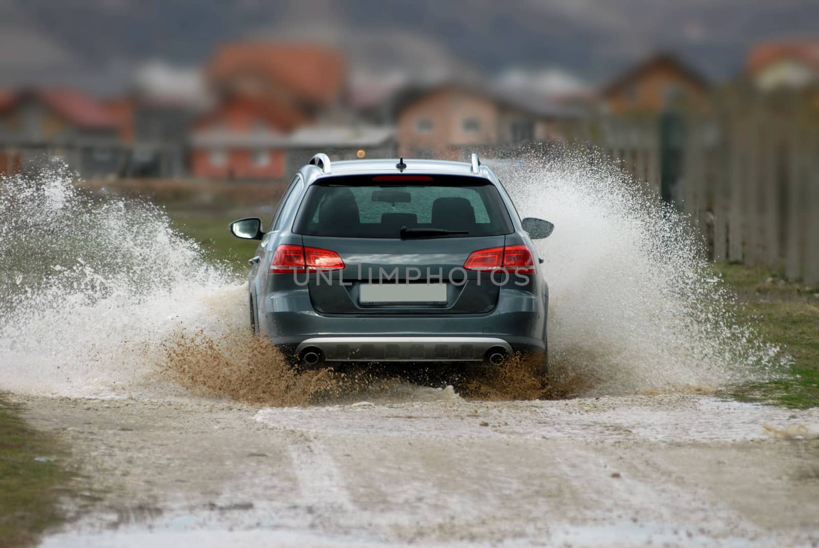 Car drives through flooded road