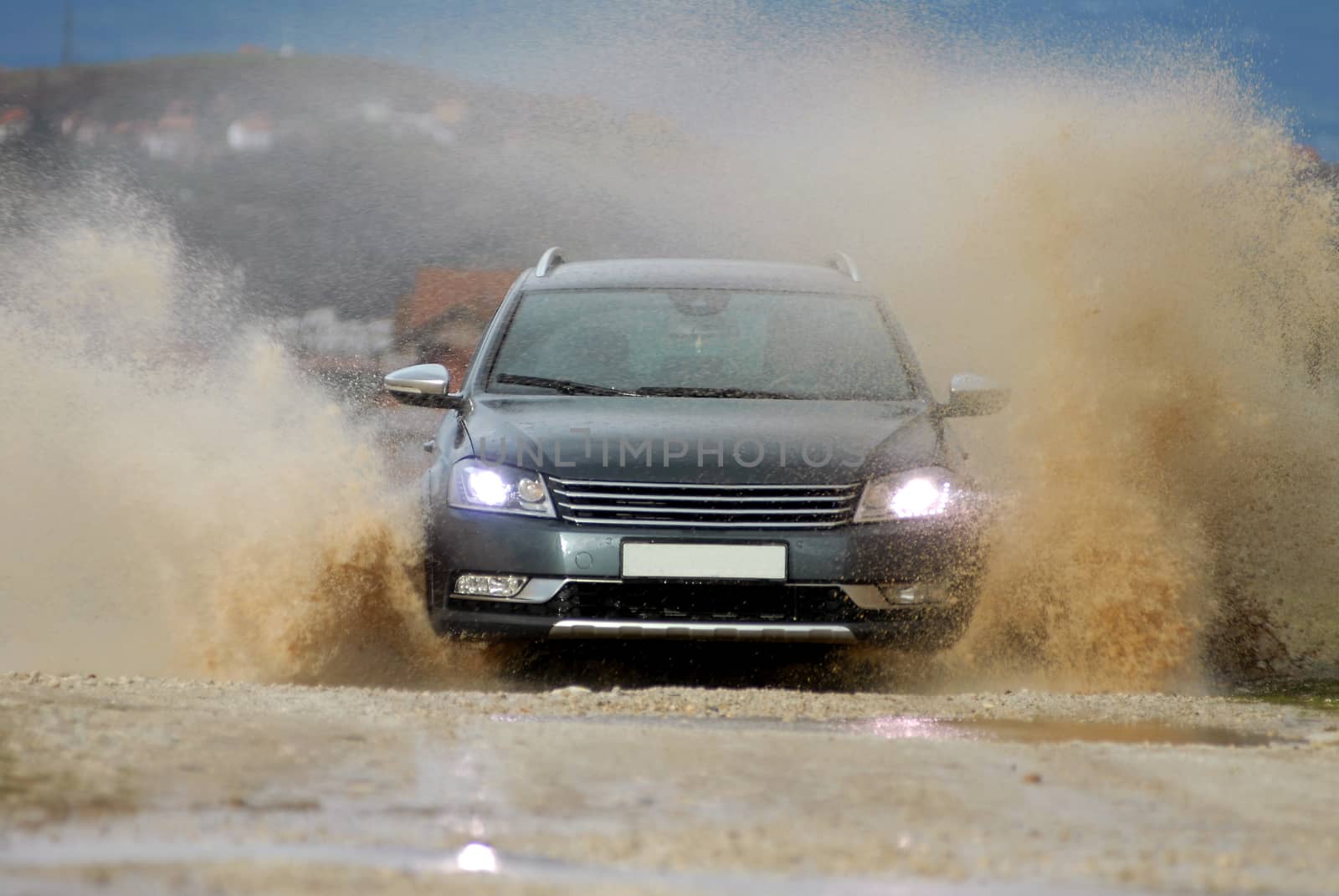 Car drives through flooded road