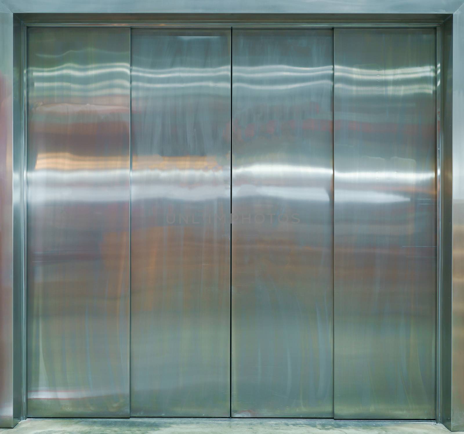 Front view of silver metal elevator with closed doors.