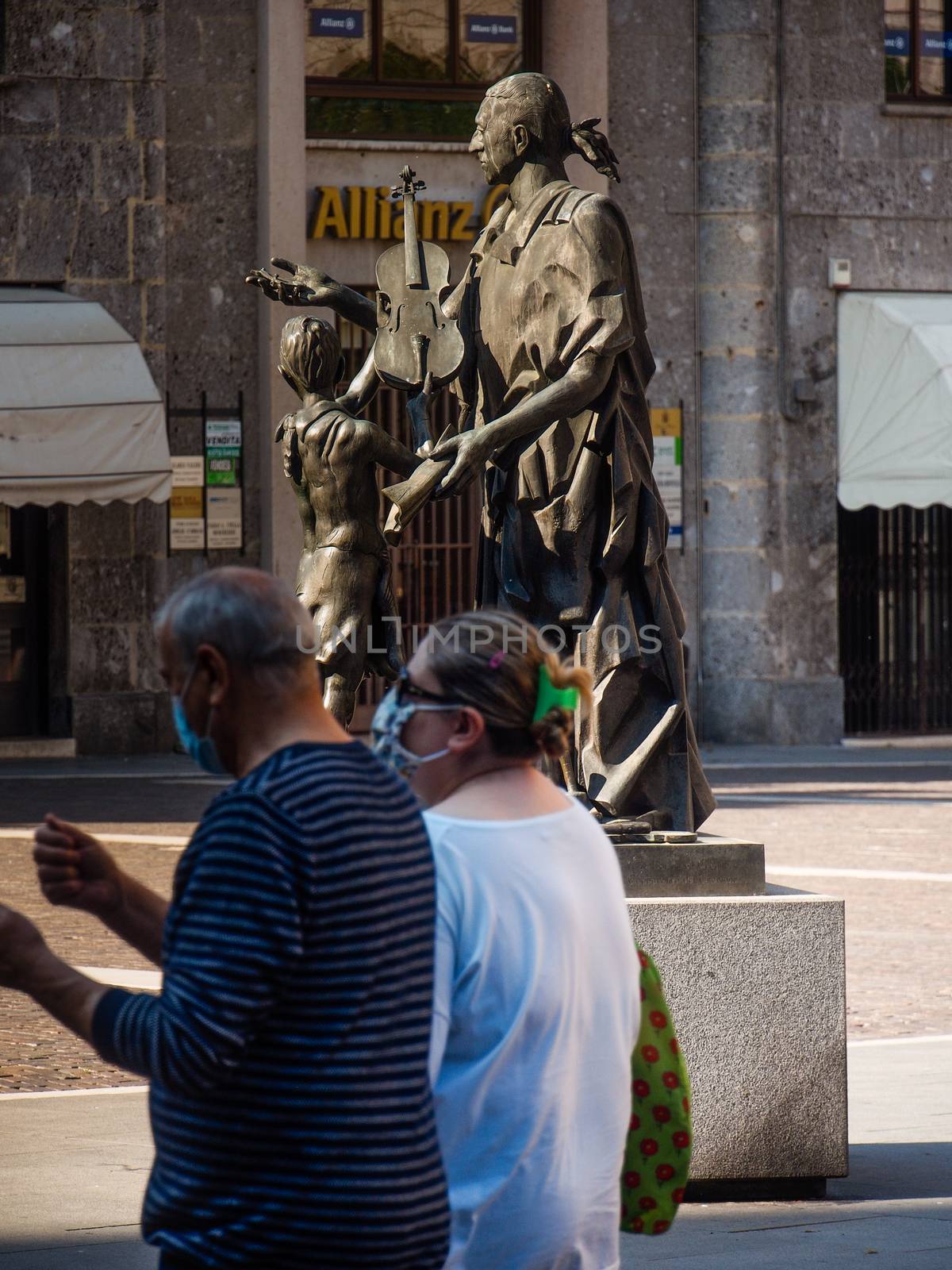 Cremona, Lombardy, Italy - May  5 6 7  2020 - man or woman walking or biking in deserted downtown  during covid outbreak lockdown phase 2