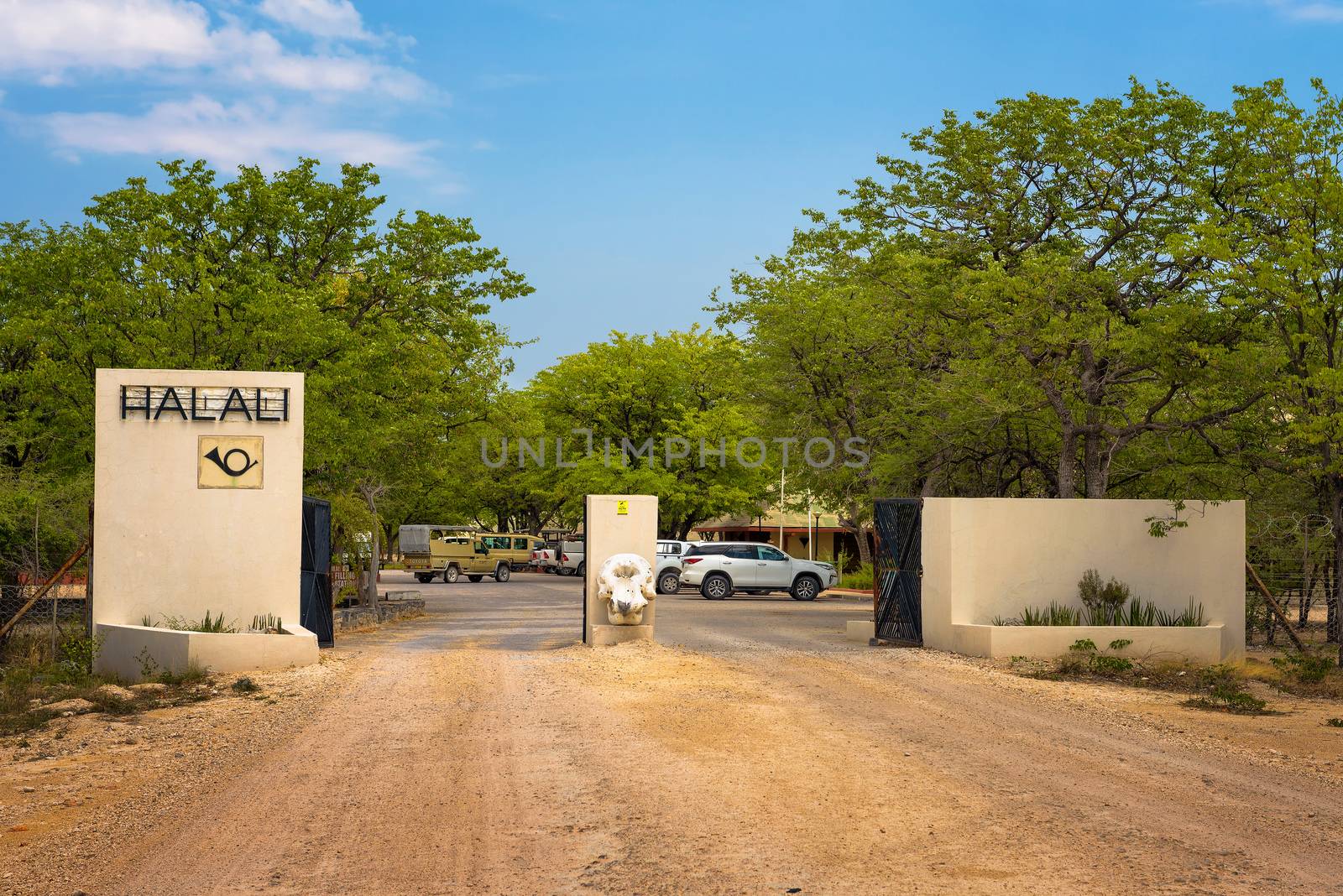 Okaukuejo, Namibia - April 3, 2019 : Entry gate of the Halali resort and campsite in Etosha National Park with an elephant skull at the entrance.