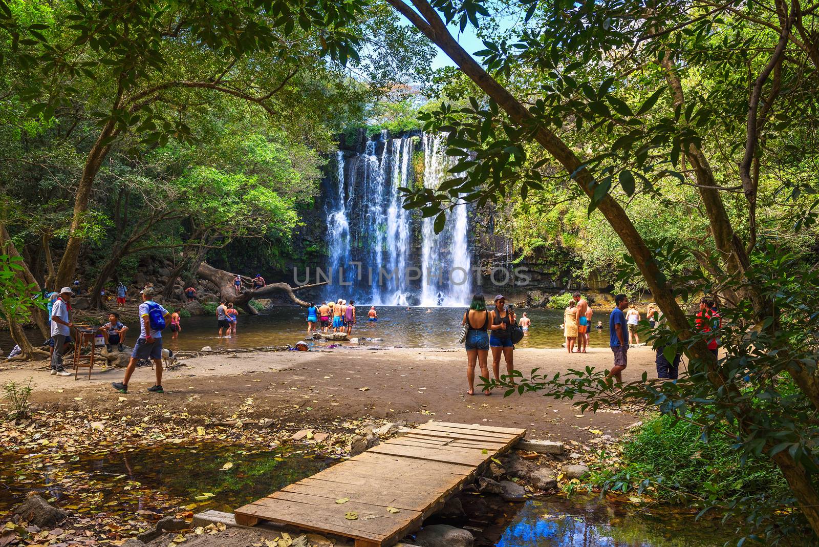 People enjoy playing and swimming at Llanos the Cortes waterfall in Costa Rica by nickfox