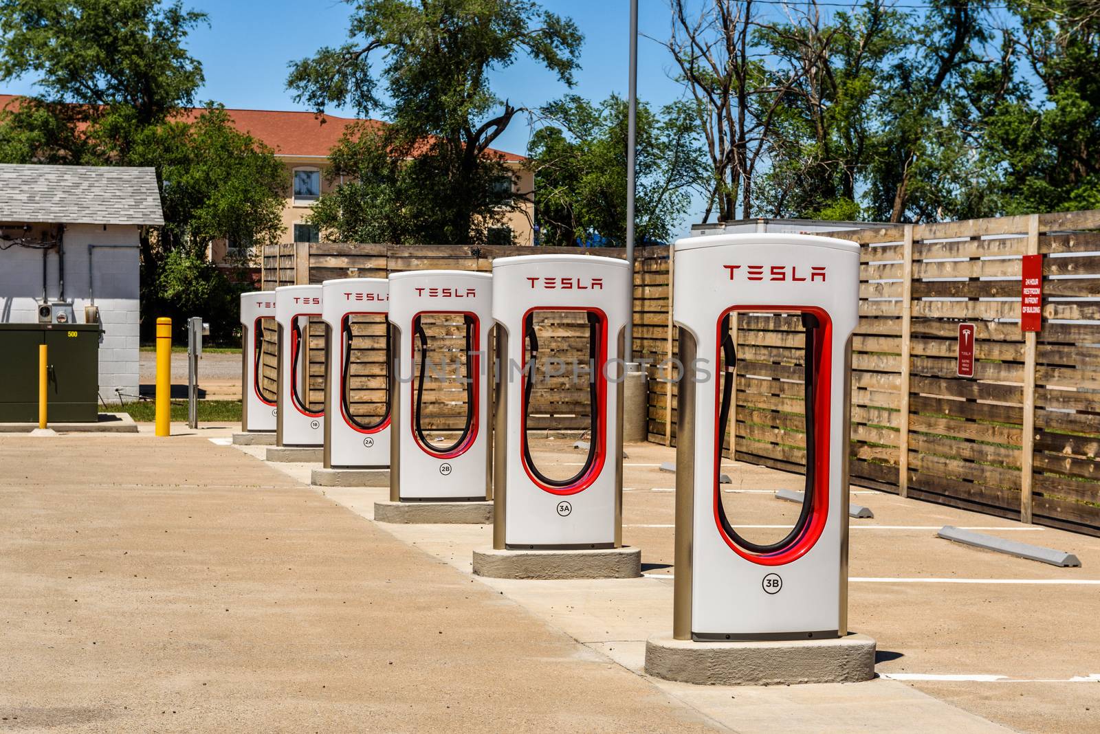 Kingman, Arizona, USA - May 12, 2016: Multiple Tesla chargers in Arizona. Tesla Supercharger is a 480-volt fast-charging station from Tesla Inc. for their all-electric cars.