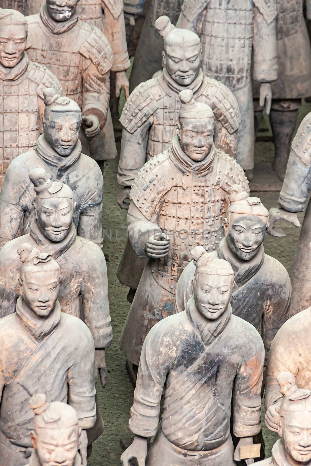 Xian, China - May 1, 2010: Terracotta Army museum and hall. Group portrait of gray-beige ancient soldier sculptures at excavation.