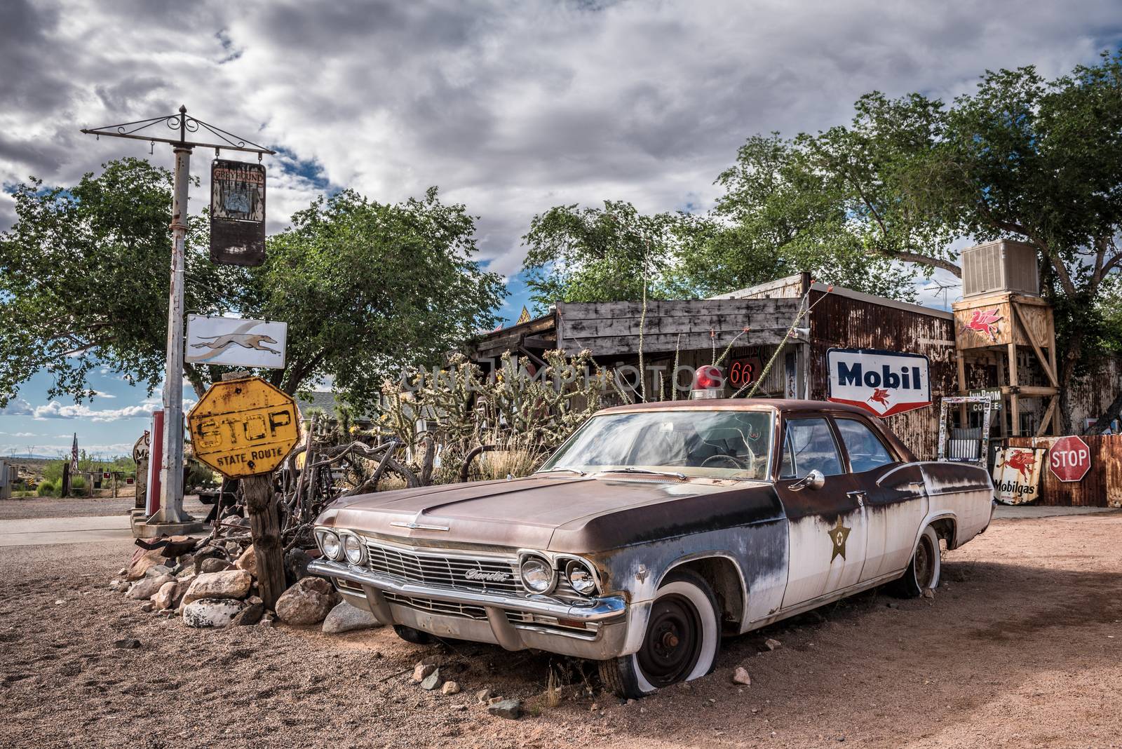 HACKBERRY, ARIZONA, USA - MAY 19, 2016 : Old sheriff's car wreck with a siren left abandoned near the Hackberry General Store. Hackberry General Store is a famous stop on the historic Route 66.